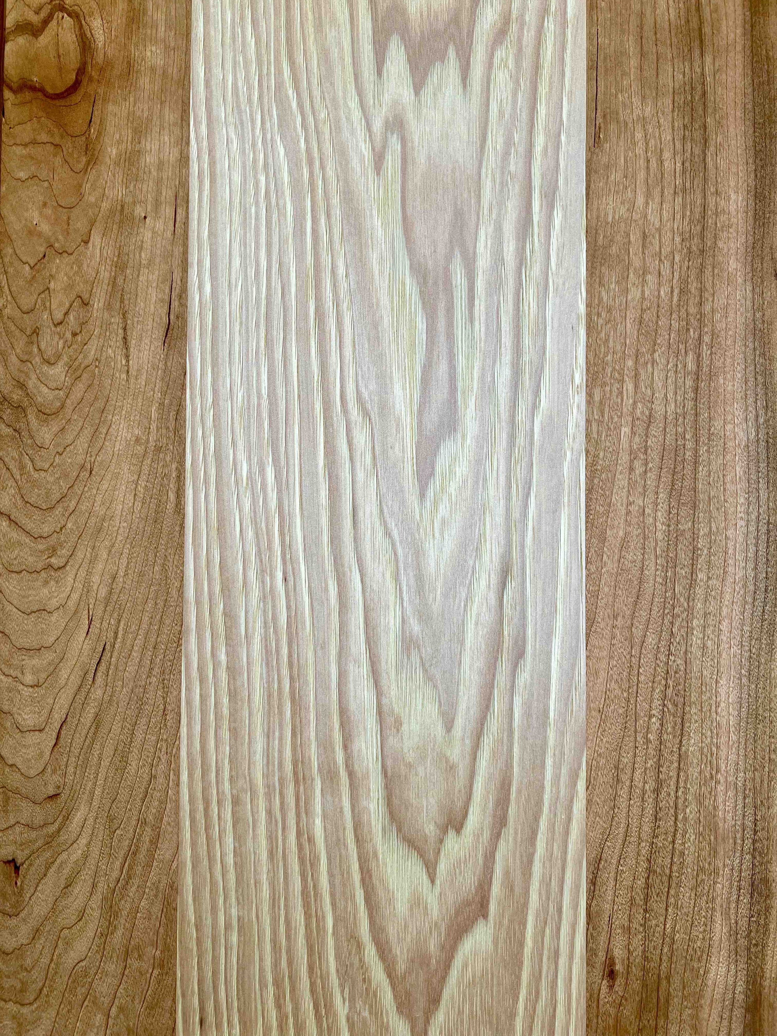 The top of a D3 Woodworks bench showing the contrast between cherry and ash lumber