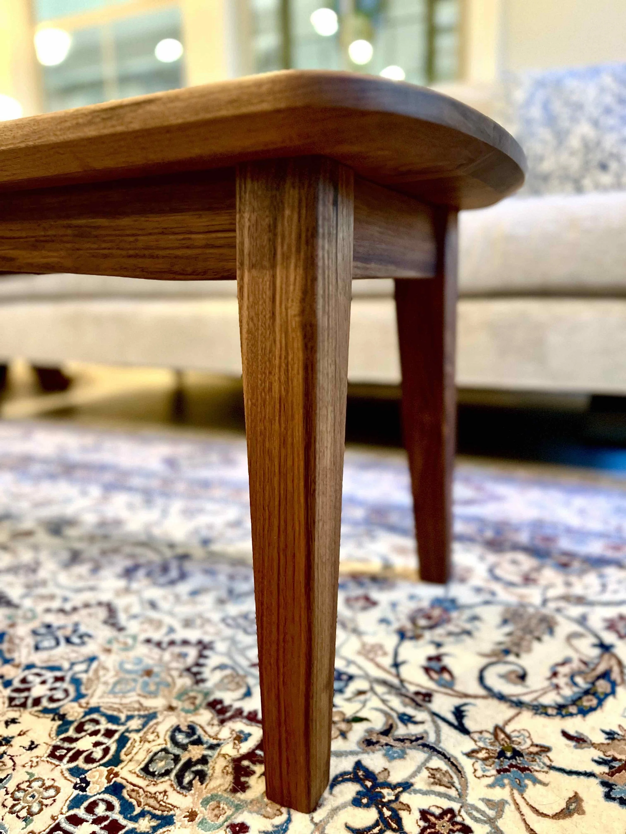 Side view of a walnut coffee table made by D3 Woodworks