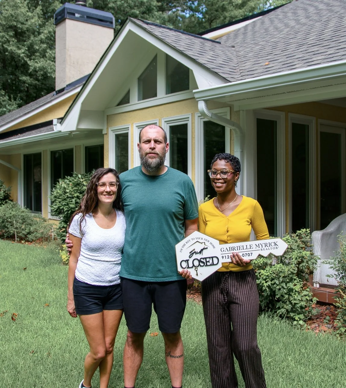 Real estate agent Gabrielle Myrick with clients who moved from Buffalo, NY to their new home in Tyrone, GA