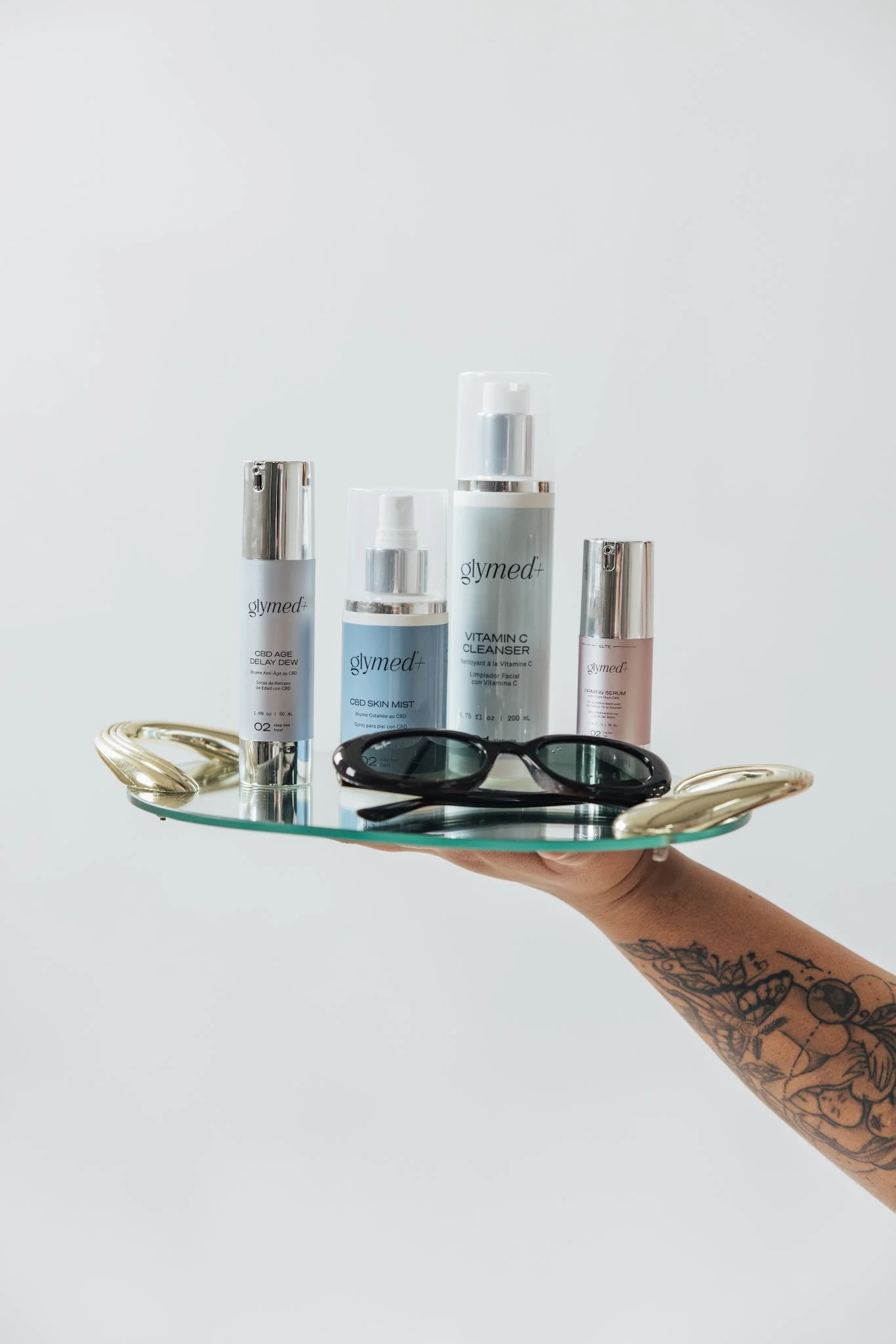 GlyMed+ Products on tray held by VitaGlow team