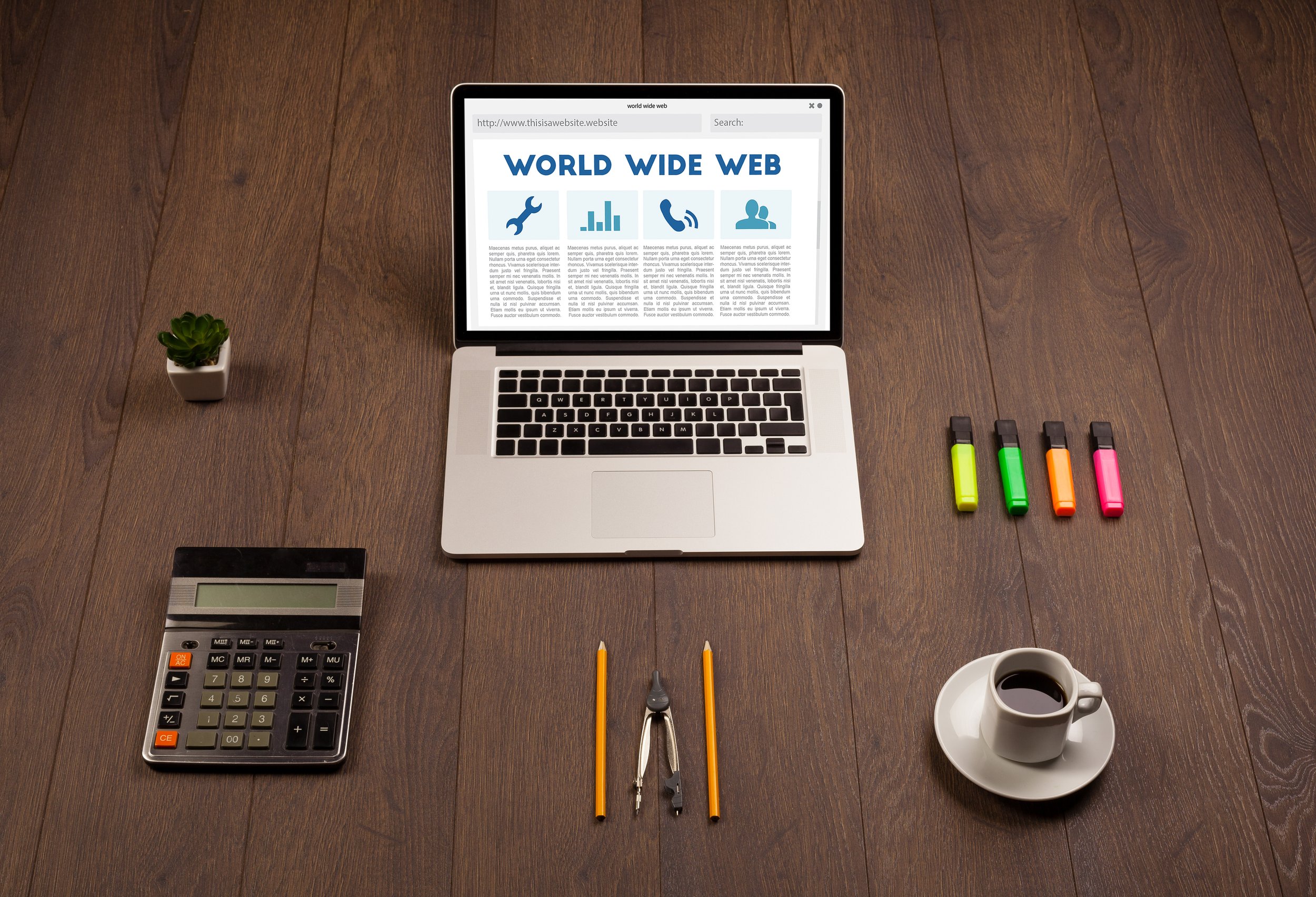 A workspace with a laptop displaying a website about the world wide web, a small potted succulent plant, a calculator, a cup of coffee, four highlighters, a pair of compasses, two pencils, and a set of tiny sticky notes, all arranged on a wooden surface.