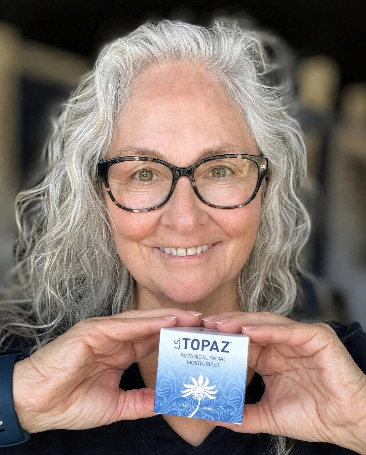 Carol McEwin holding LS.Topaz Botanical Facial Moisturizer