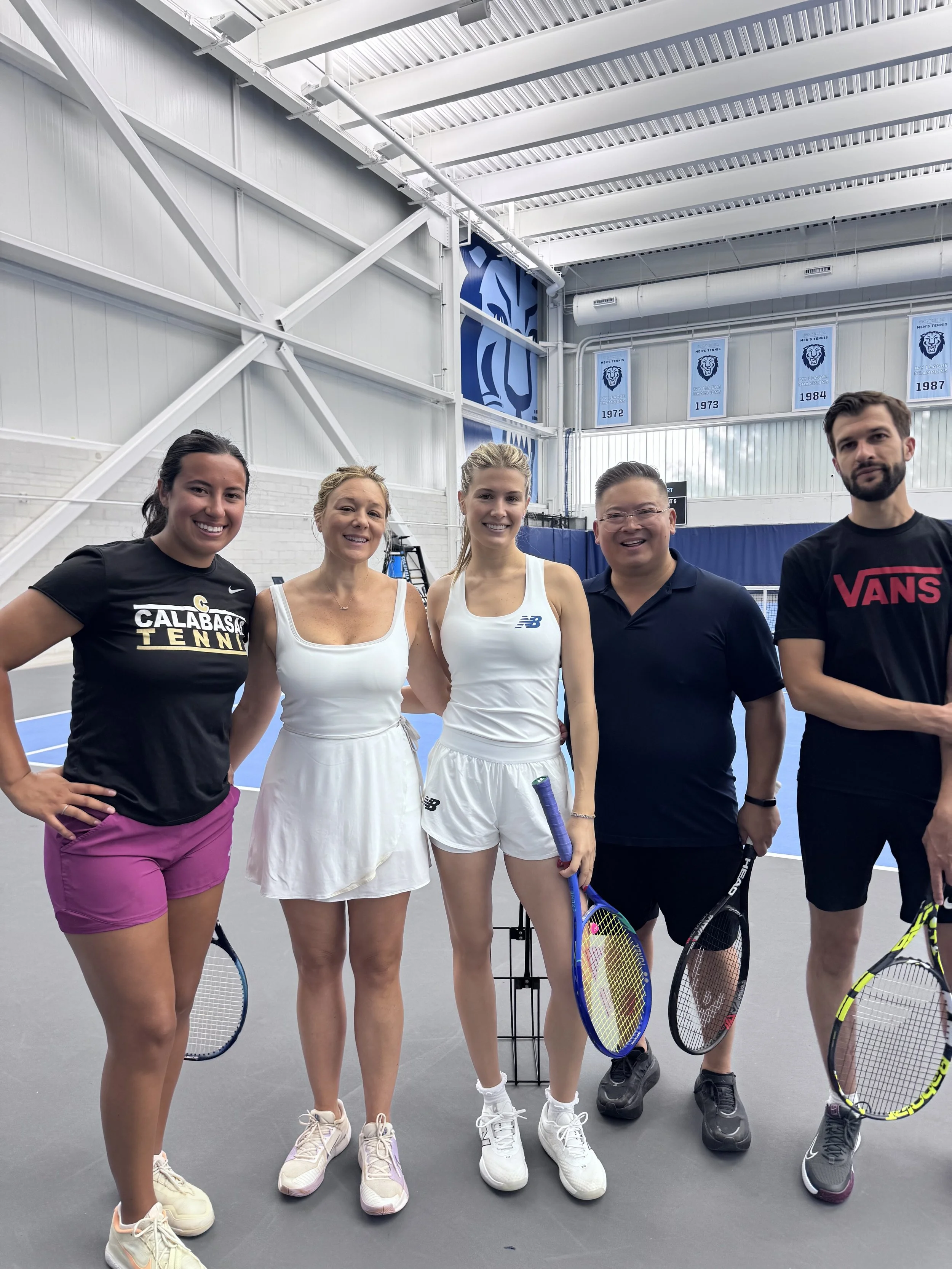 Academy Day NYC guests smiling together with their tennis racquets.