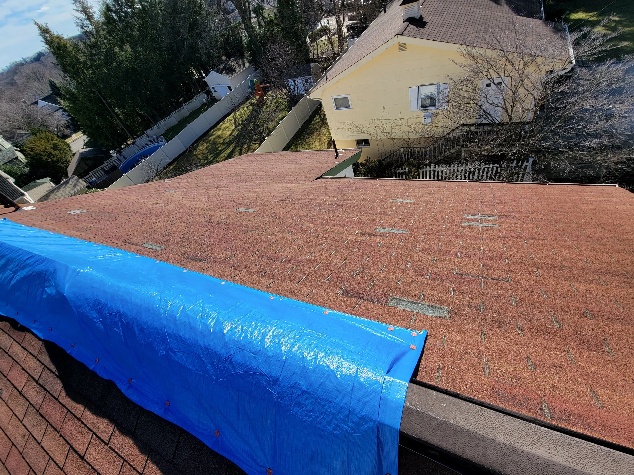 Tarped roof with missing shingles in Caldwell, NJ — emergency roof repair by David Ryan Roofing & Exteriors
