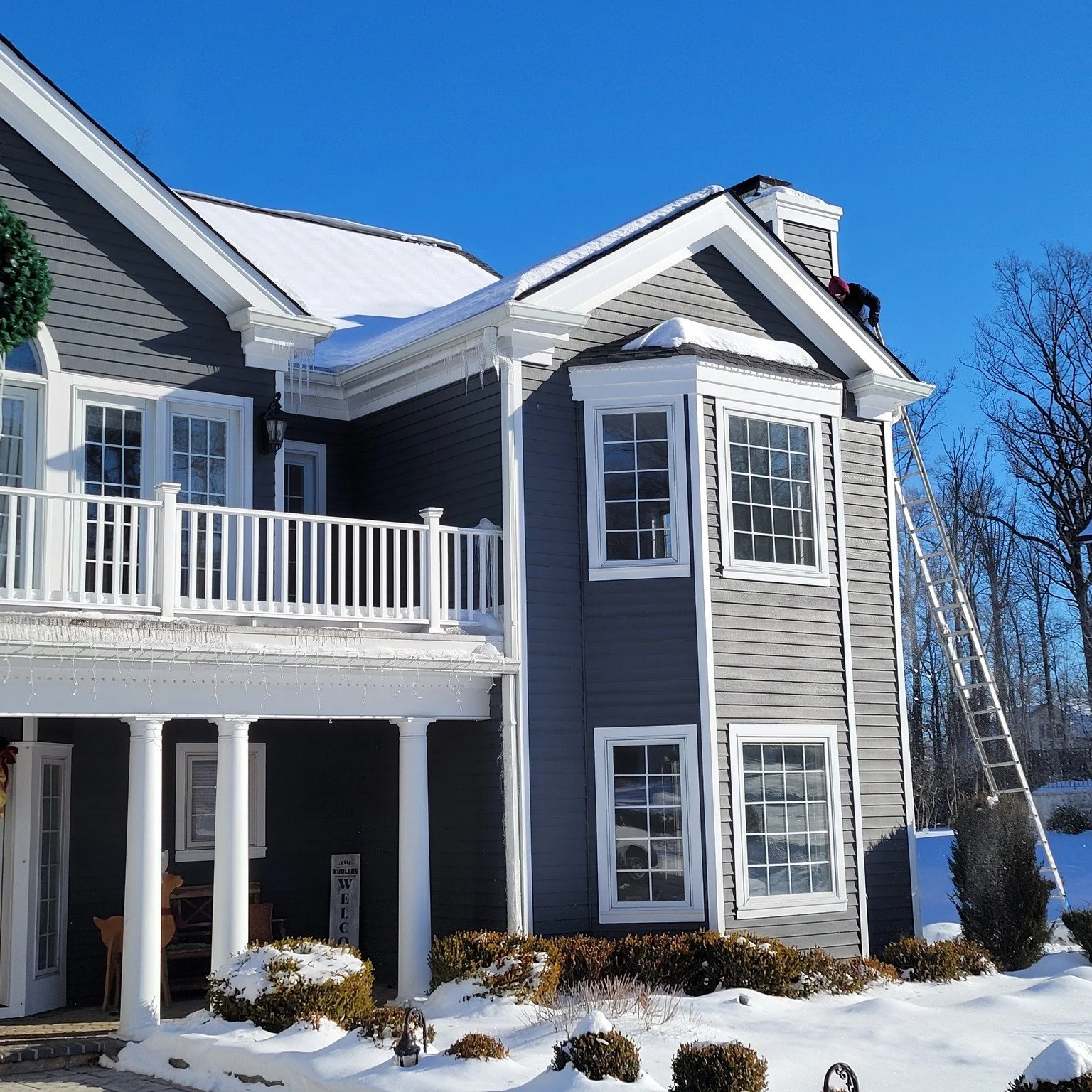 North Caldwell, NJ—Dave scaling a ladder for snow removal and ice dam mitigation after an interior leak.