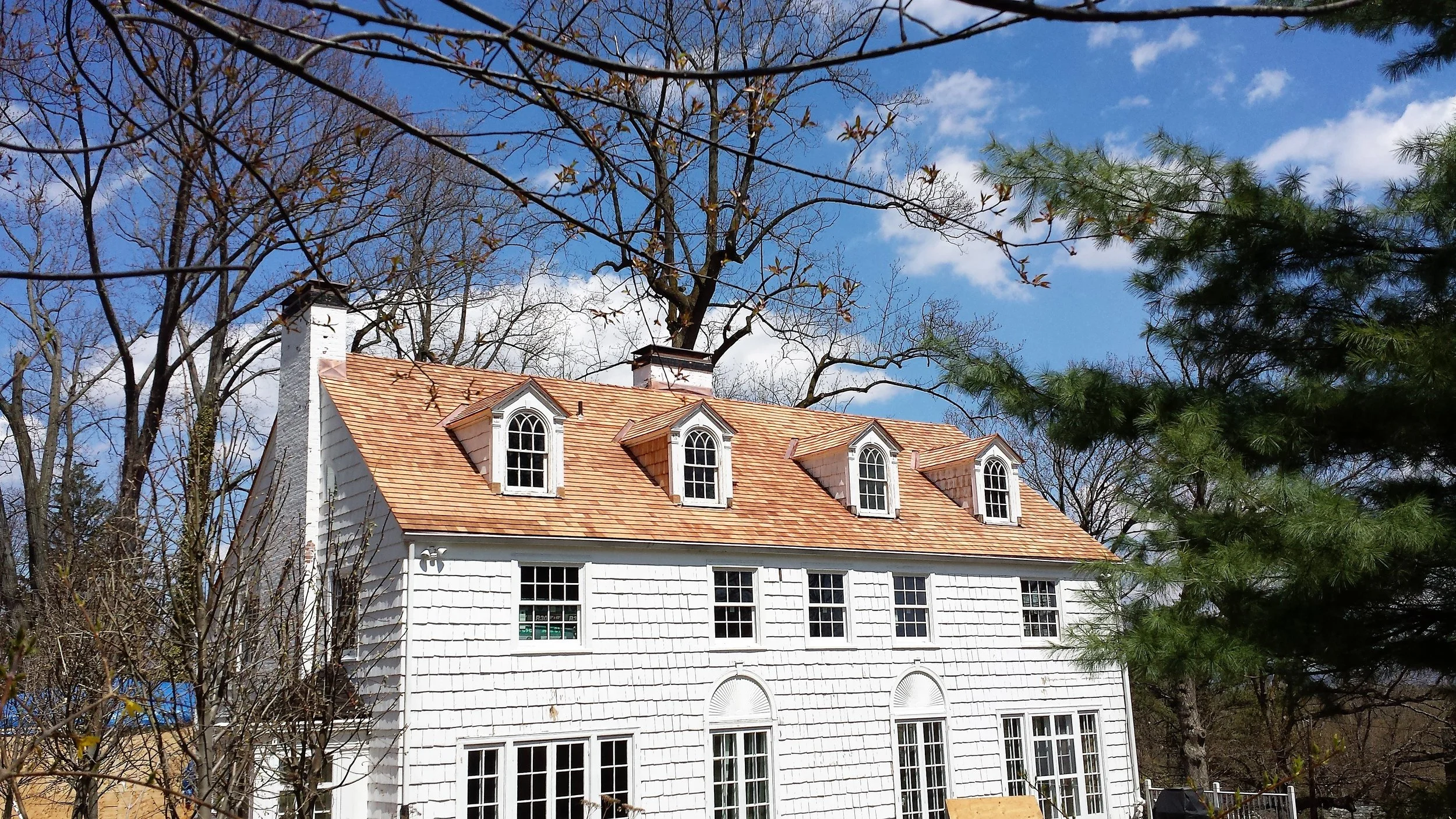 Cedar roof installation in progress—installing cedar shingles/shakes and detailing for weather protection.