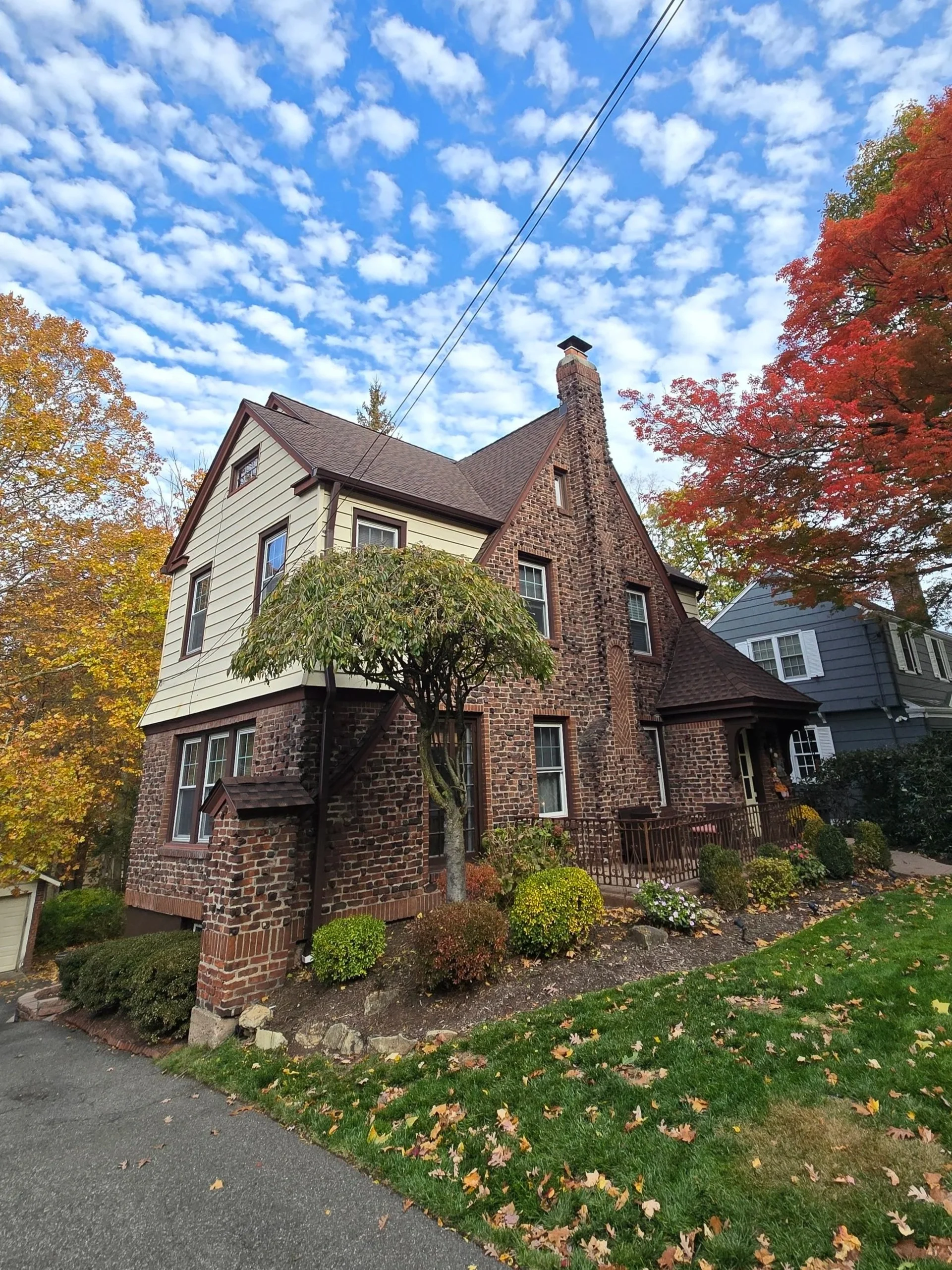 Full roof and gutter replacement—cedar shake removed, roof re-sheathed, and GAF Timberline HDZ Hickory shingles installed.