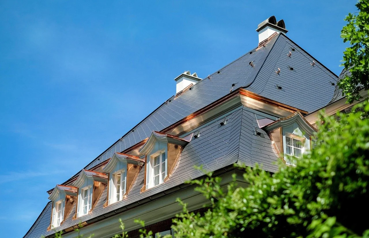 Slate roofing with copper accents—stock image used to represent slate and copper work.
