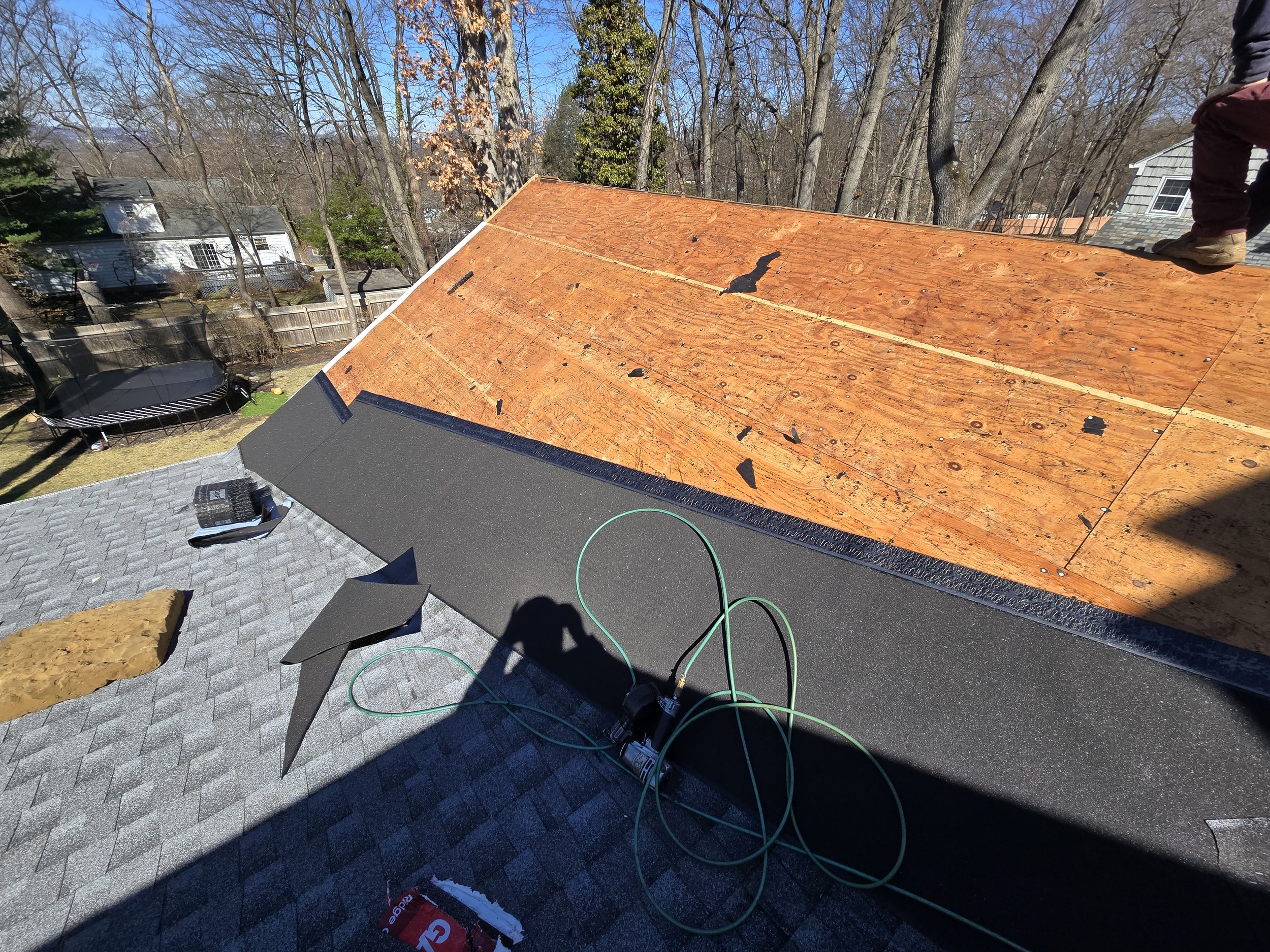 Valley tie-in detail: ice and water shield overlapped to integrate existing roof with new roof section.