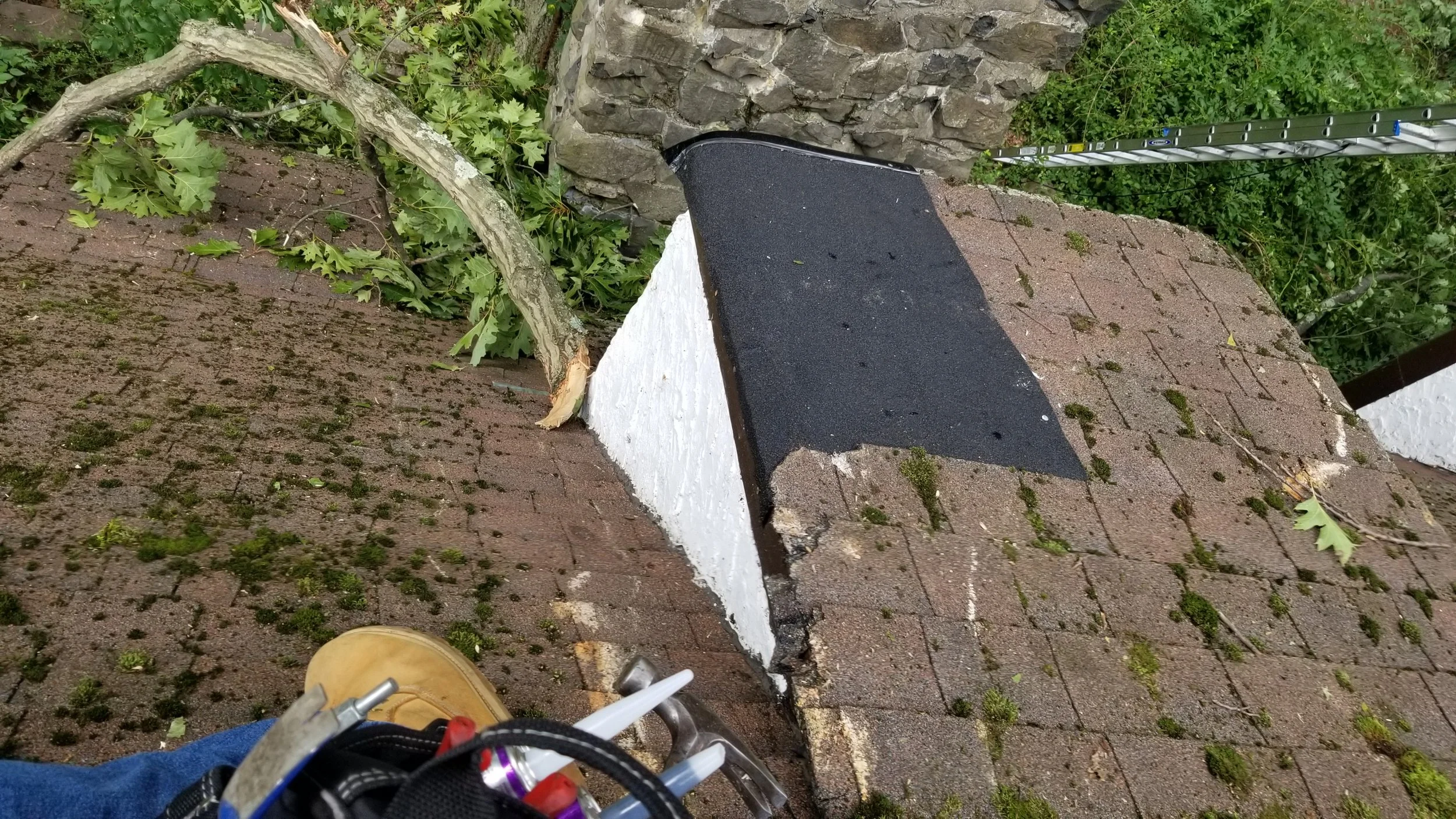 Montclair, NJ—roof repair after a tree limb damaged a dormer (emergency repair in progress).