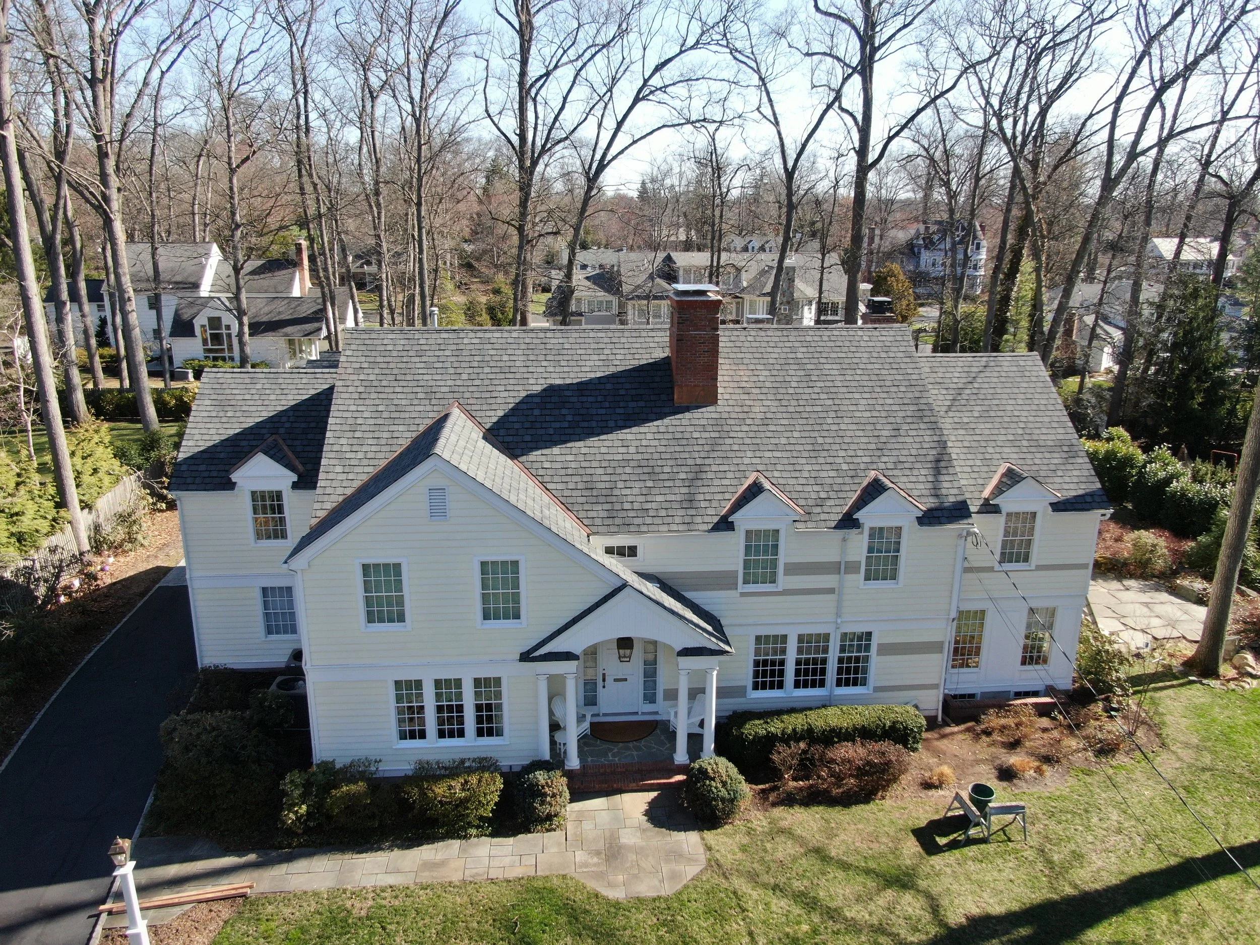 Full roof replacement in North Caldwell, NJ with CertainTeed Belmont shingles, copper valleys, and new copper chimney flashing.