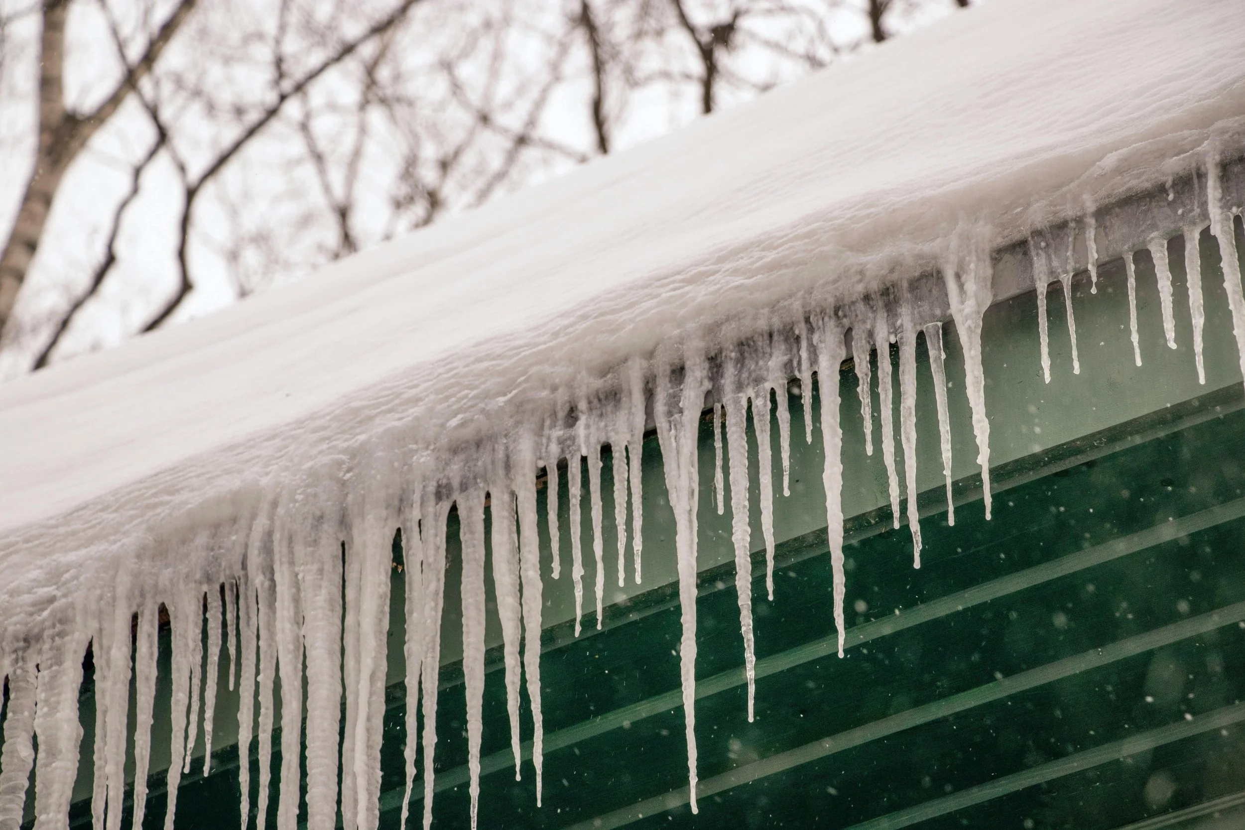 Heavy ice damming resulting in icicles and heavy snow load on top of roof.