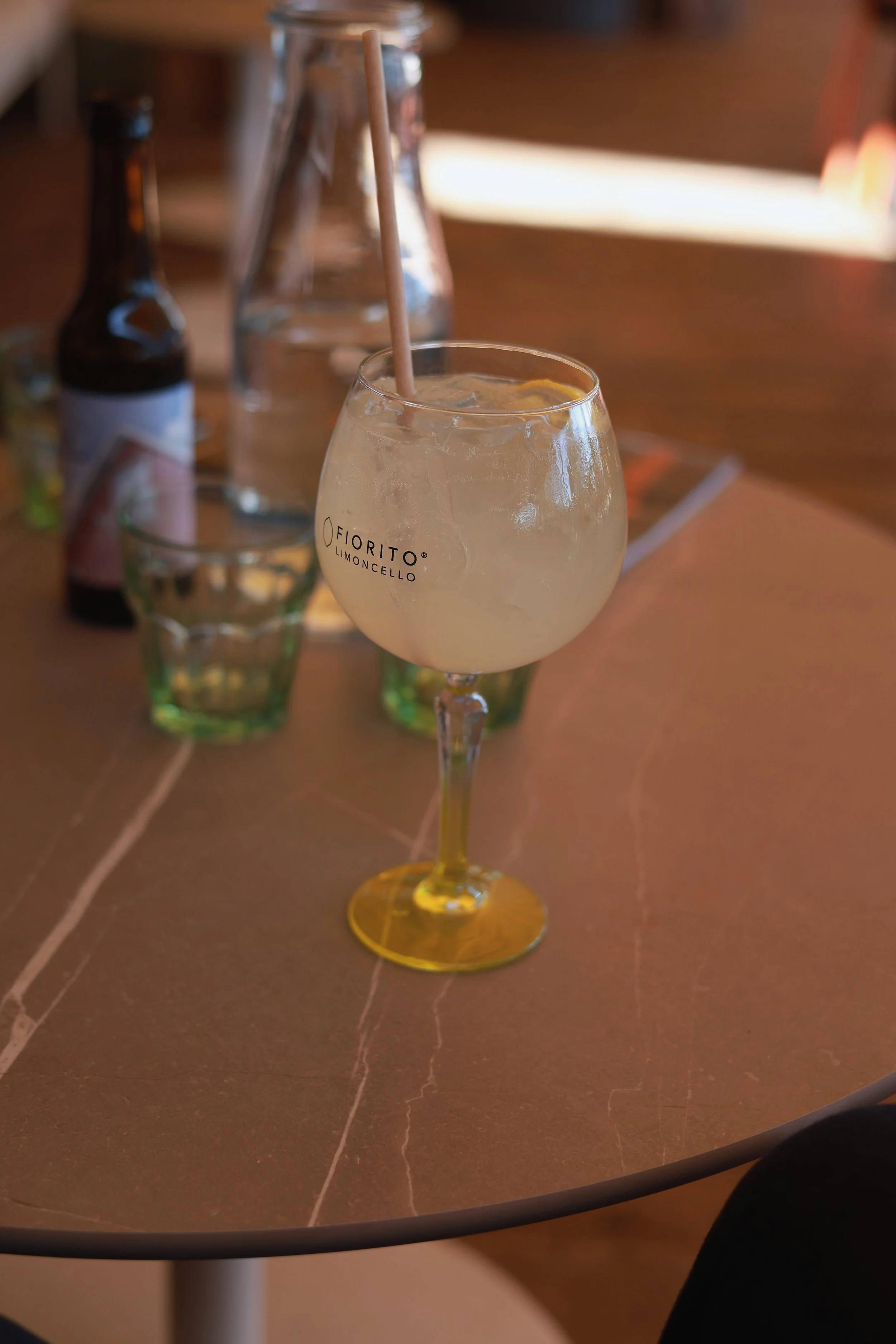 A drink on a café table during a quiet pause beside the harbour.