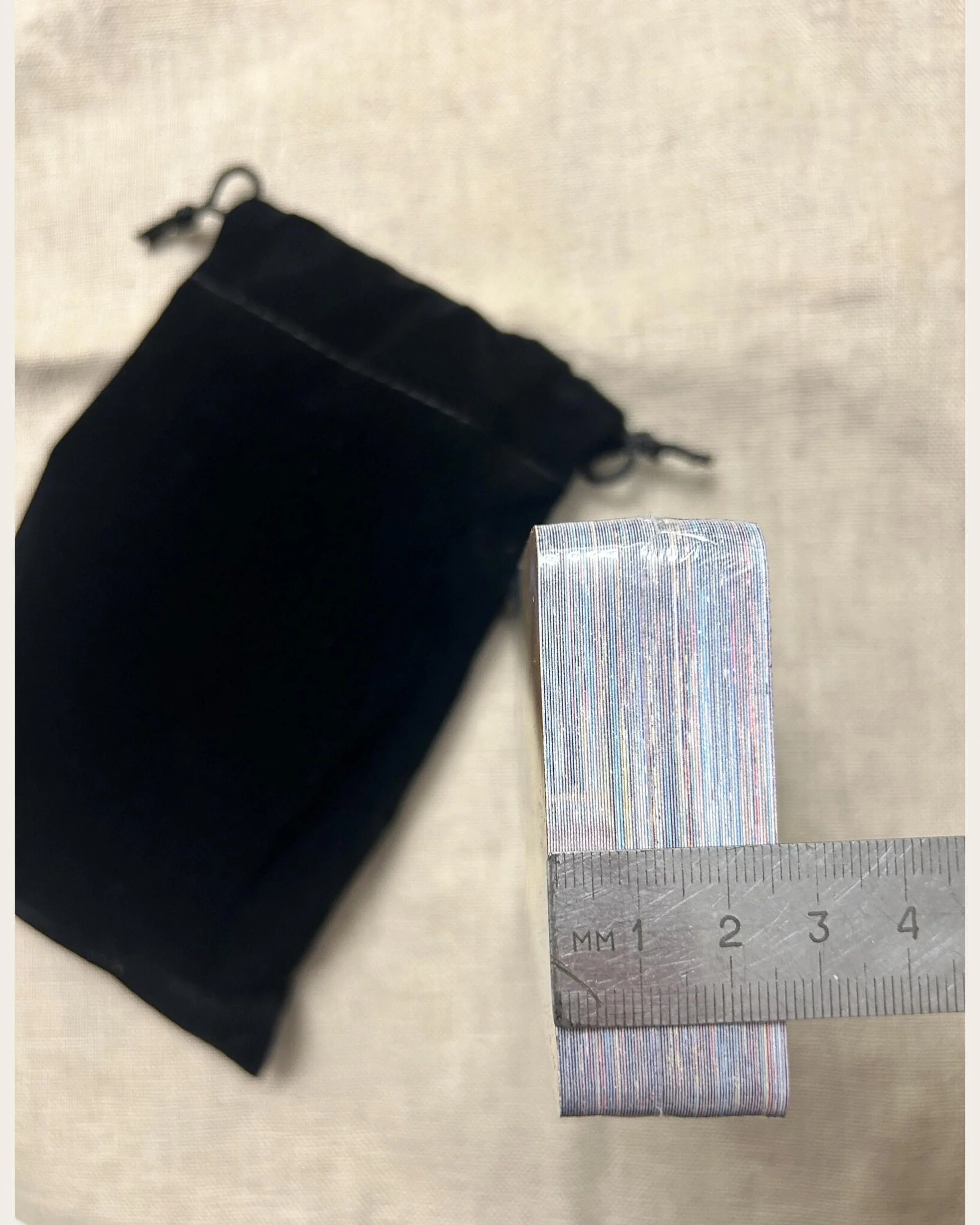 Wrapped Mystic Nomad The Beginner’s Path Tarot deck with holographic edges beside a ruler.