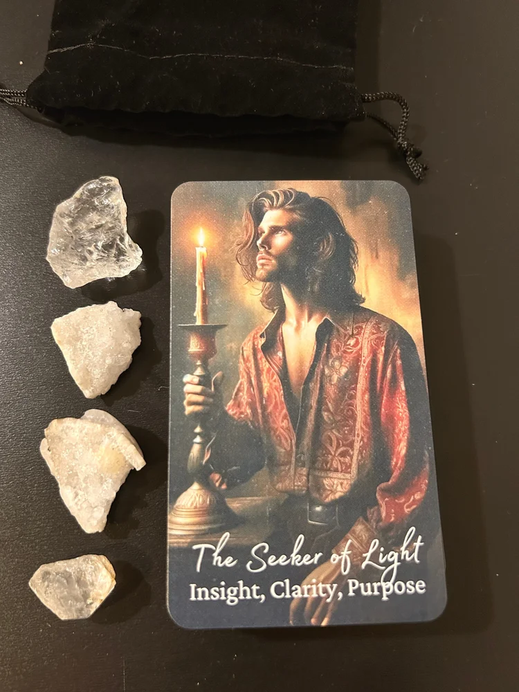 The Seeker of Light card showing a man holding a lit candle beside crystals on a dark surface.