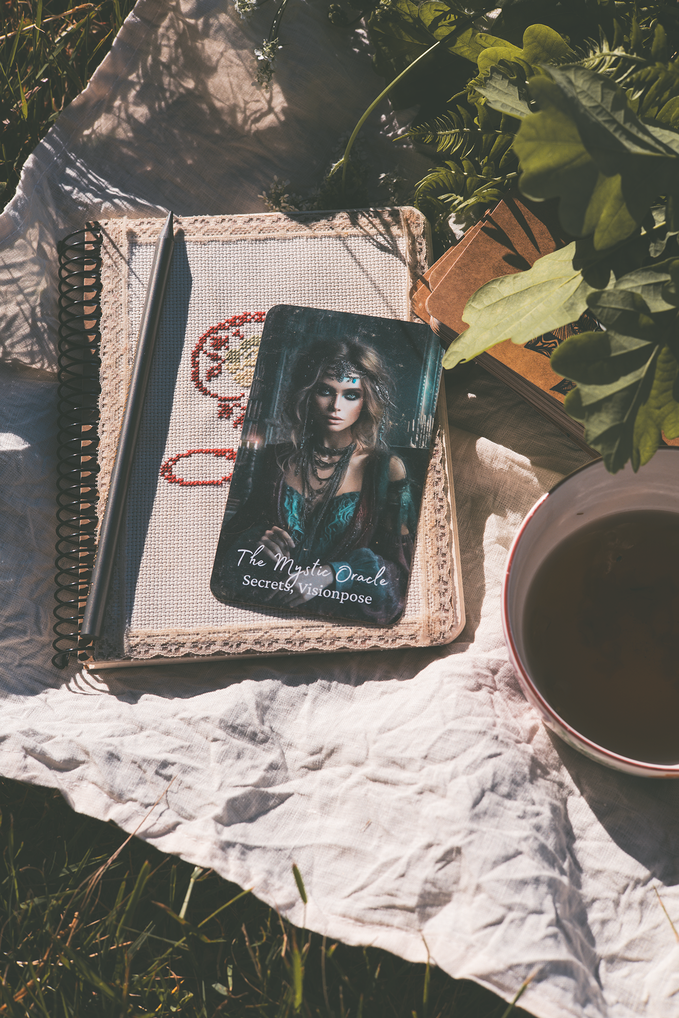 The Mystic Oracle card resting on a journal beside tea