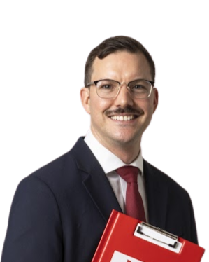 A smiling man in a business suit holding a red folder with the Labour Party logo.
