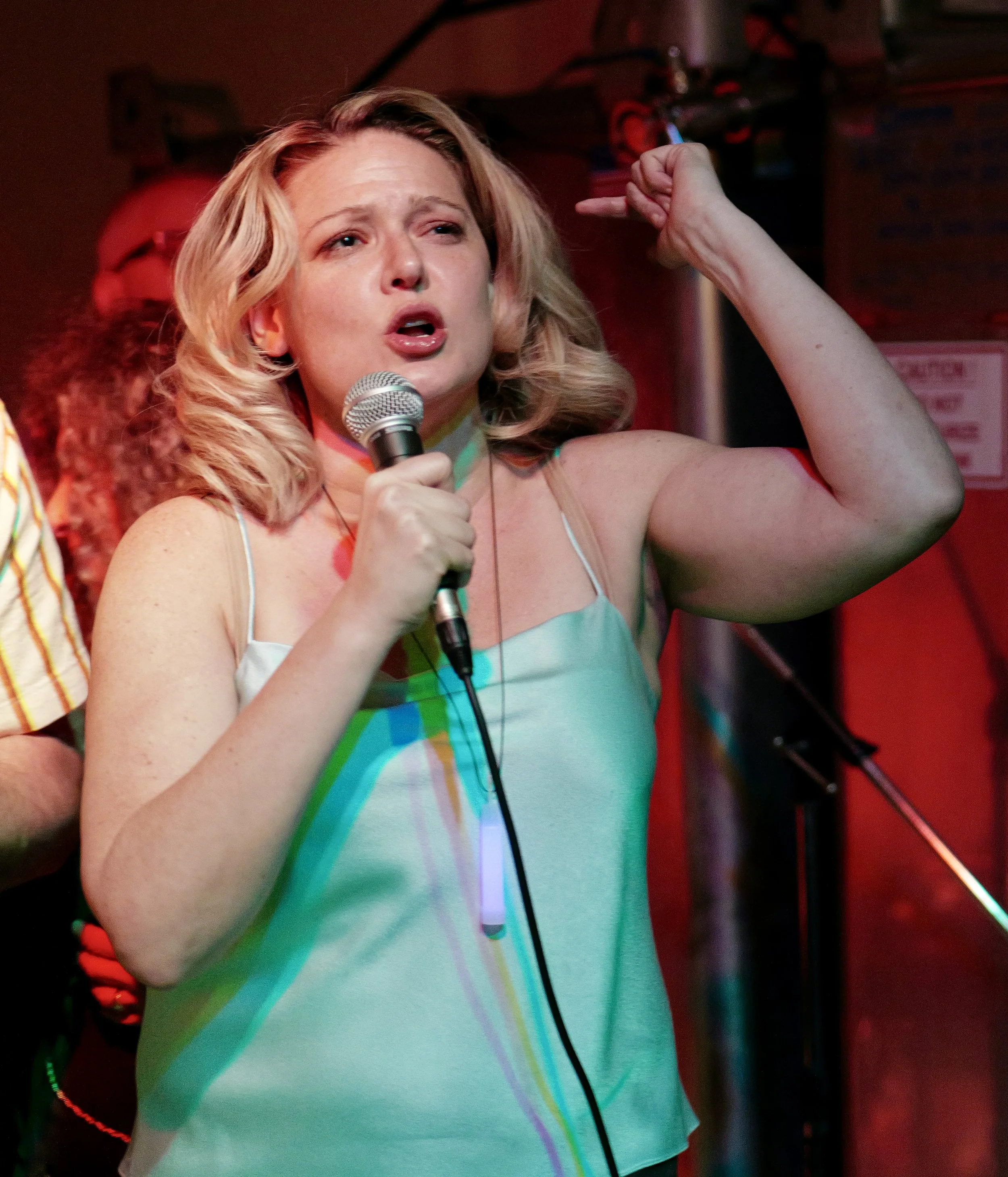 jackie at mic finger.JPG