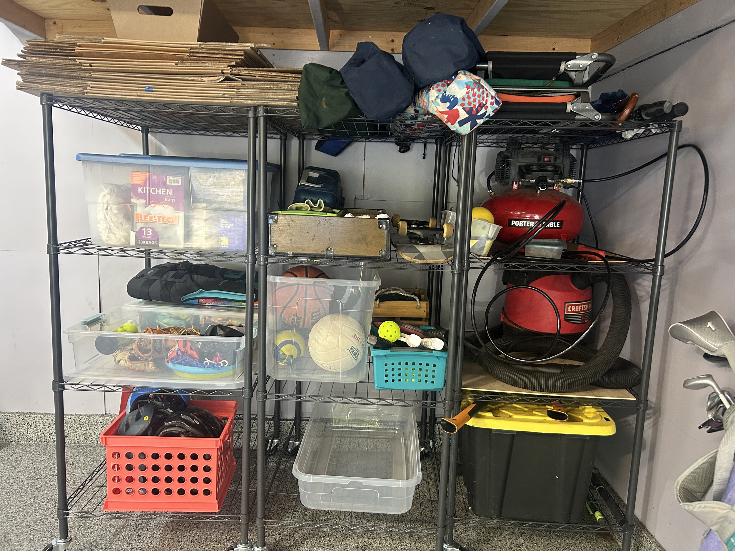 garage shelving with chairs, toys, boxes and camping supplies