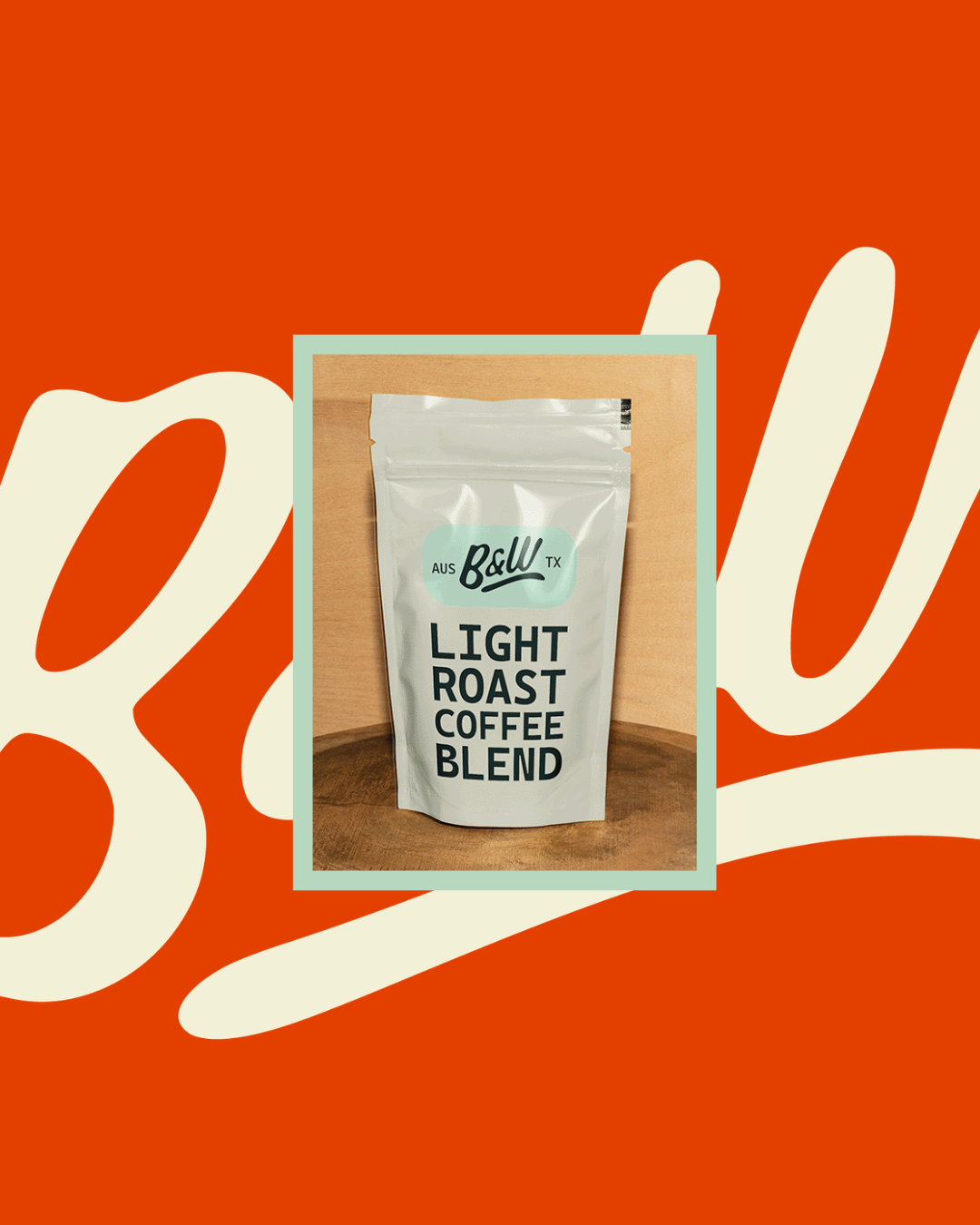 A white bag of light roast coffee blend from Ball Coffee Co., placed on a wooden surface against a light wood background.