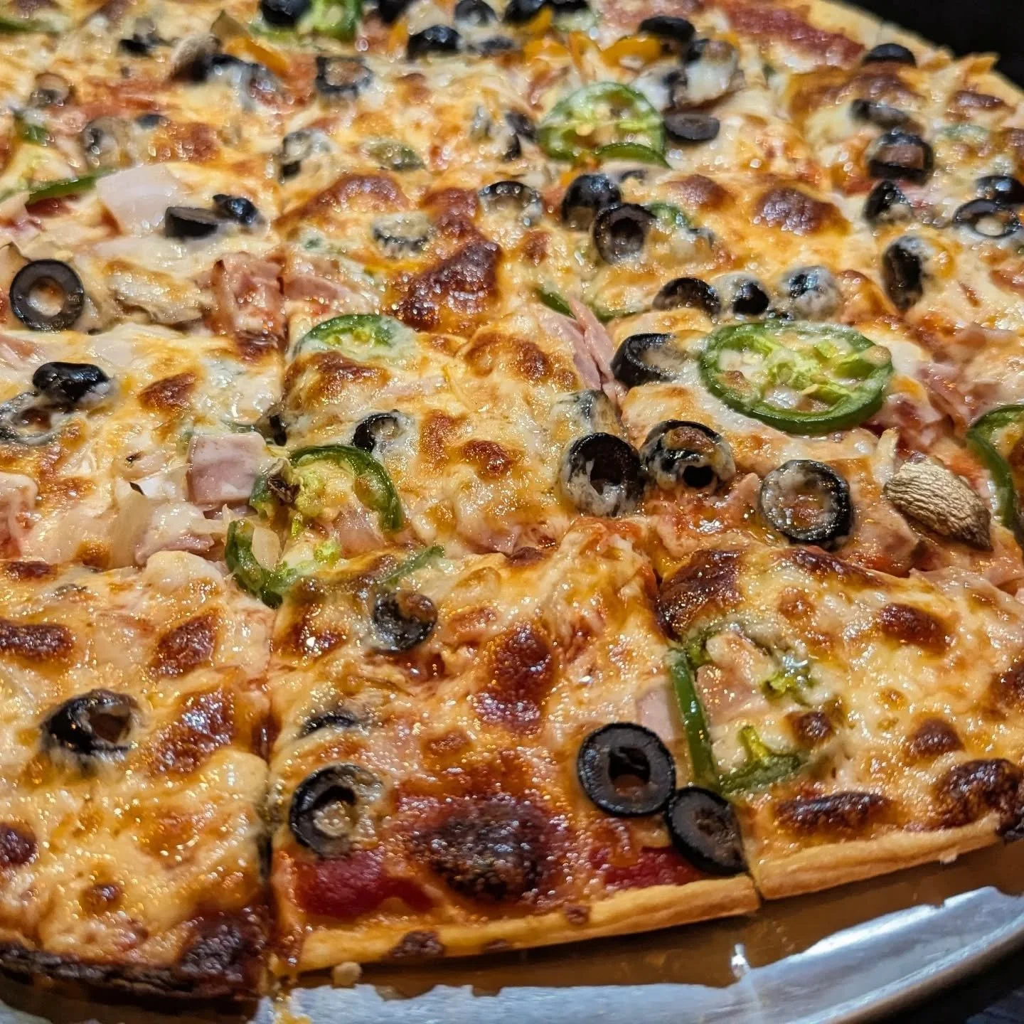 We have pizza hut thin crust at home. Cracker thin crust with half pepperoni, mushroom, onion, peppers, black olives, jalapenos. Half ham, onion, jalapeno, black olive. Party squares for the win!