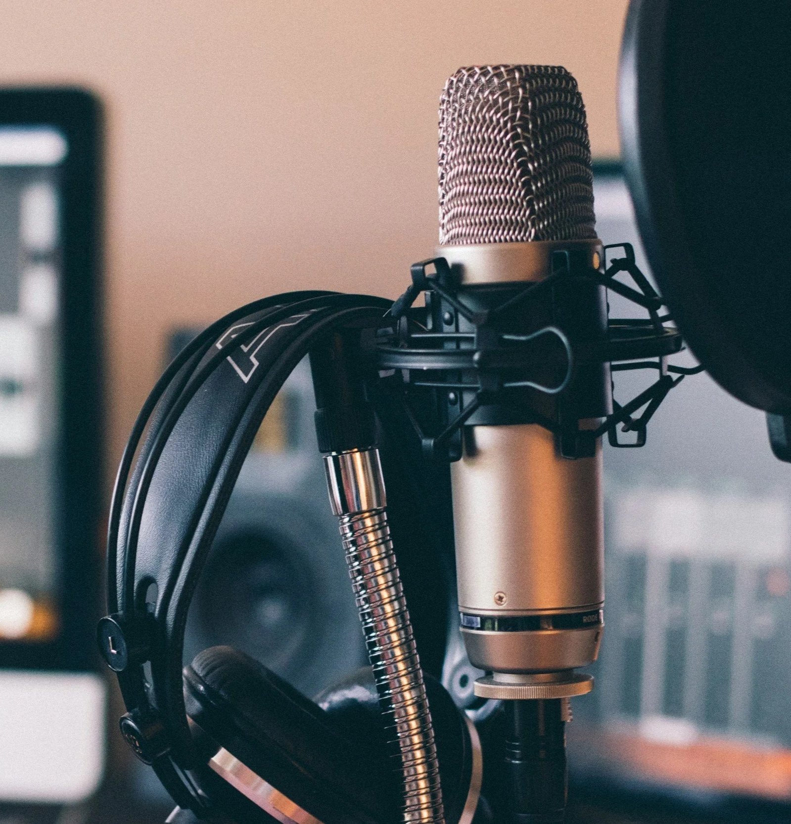 Studio microphone, headphones, and a computer monitor.