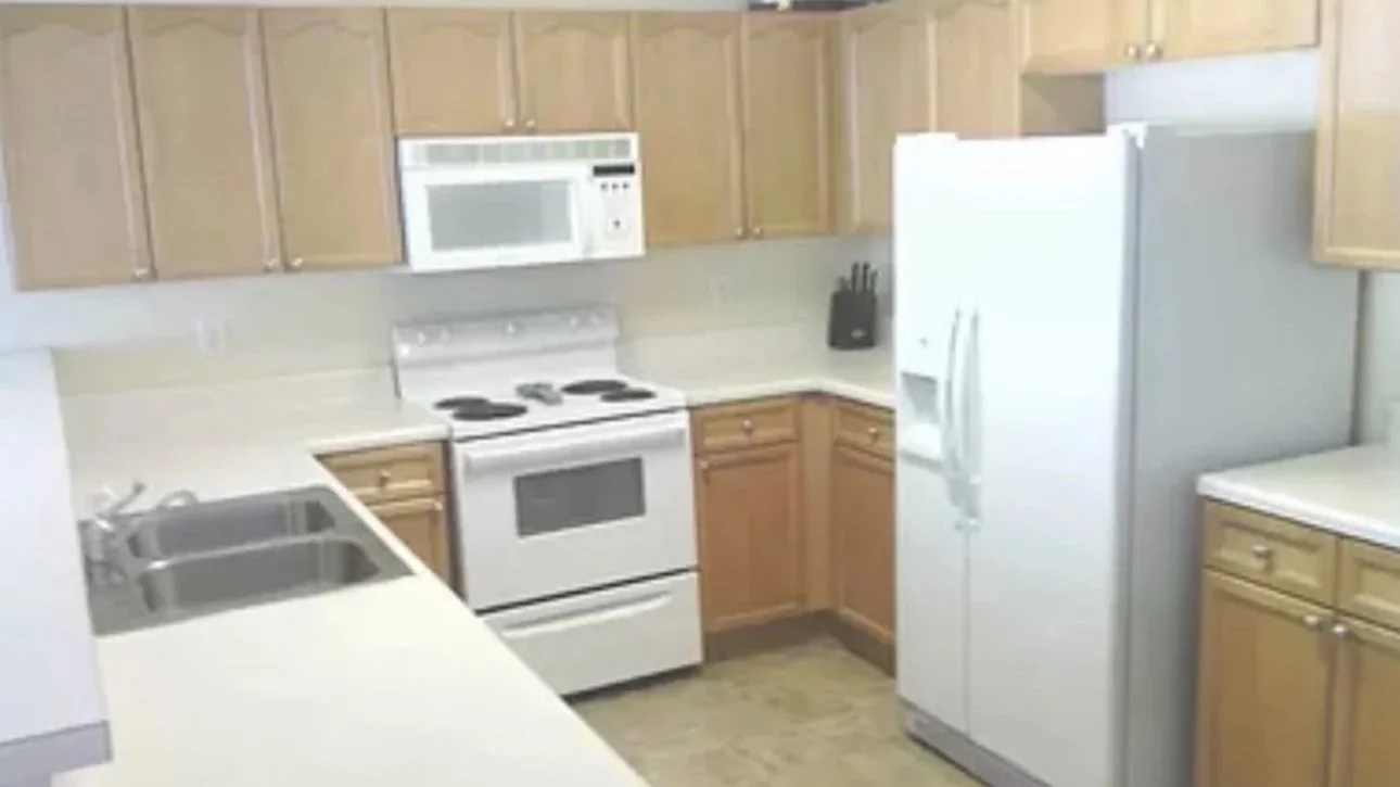 Kitchen space with original cabinetry and neutral finishes, representing a before stage in a home transformation. This image highlights renovation potential, interior design planning, and home staging opportunities in Atlanta homes.