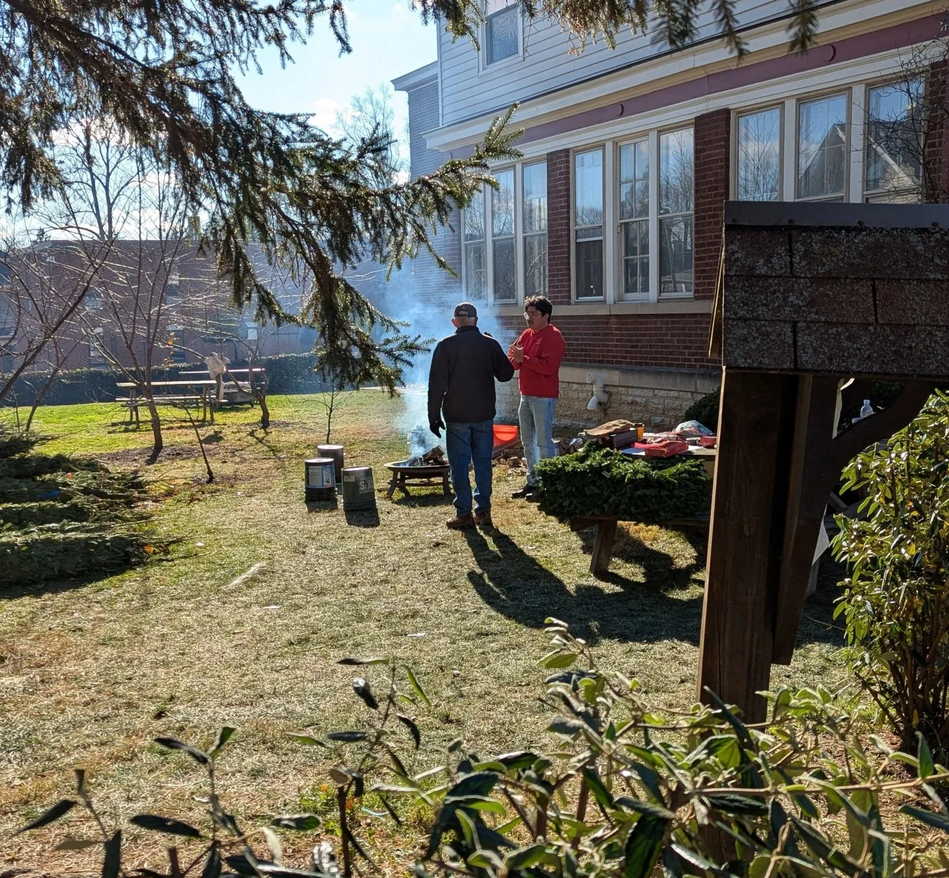 GK Matt Okiishi and Brother Tom Lieser warm themselves at the fire, uneventfully, at the Eastside Family Tree Sale 2025. 