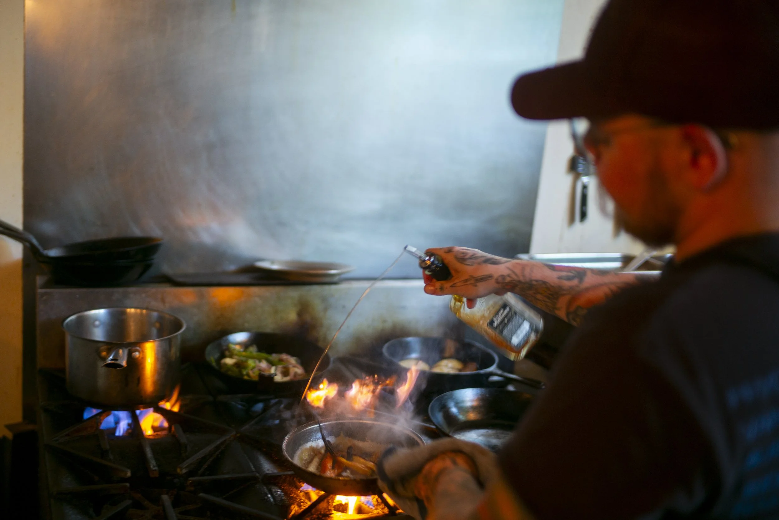 Executive Chef John deglazes a pan of roasted vegetables