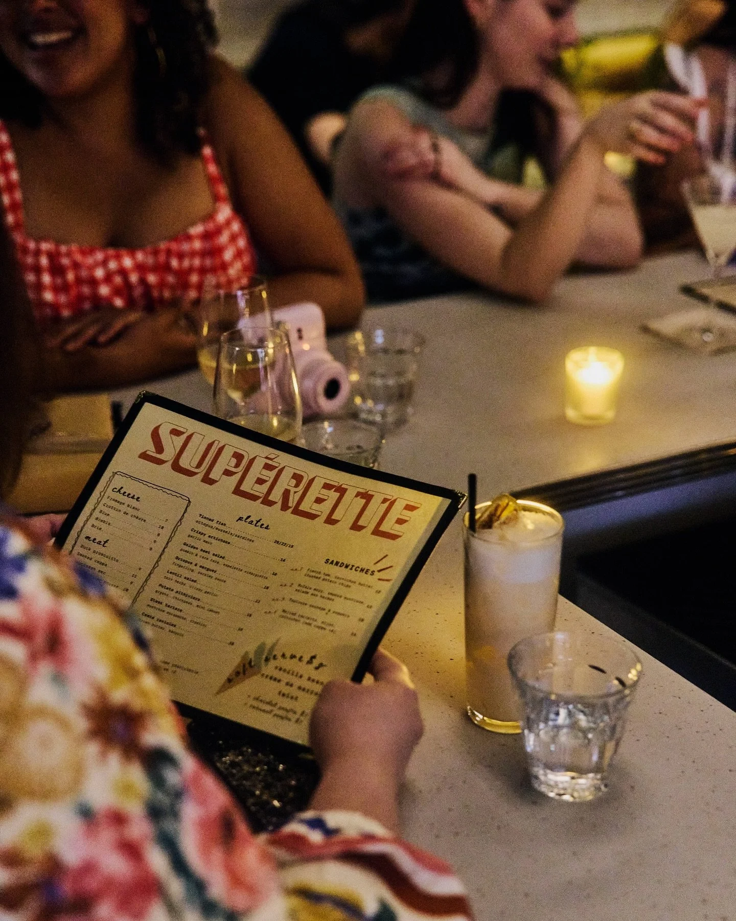 Sun setting, lights dimming — slide through for a cocktail at the bar 🛝🍹