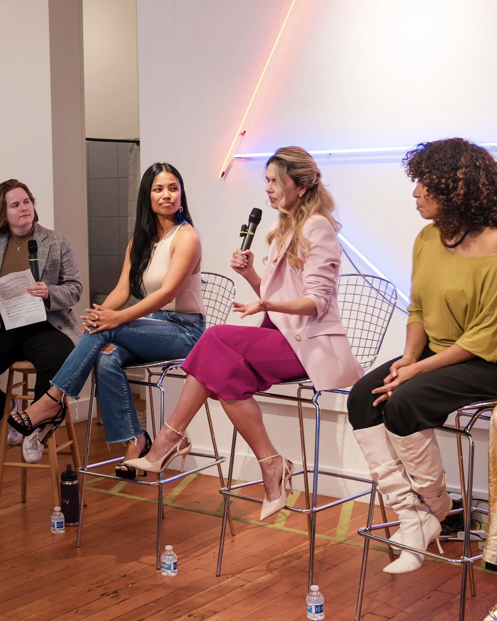 Kate Ziuz speaking to an audience, squared to the room with an open, grounded stance — stage presence mechanics she teaches women leaders and founders.