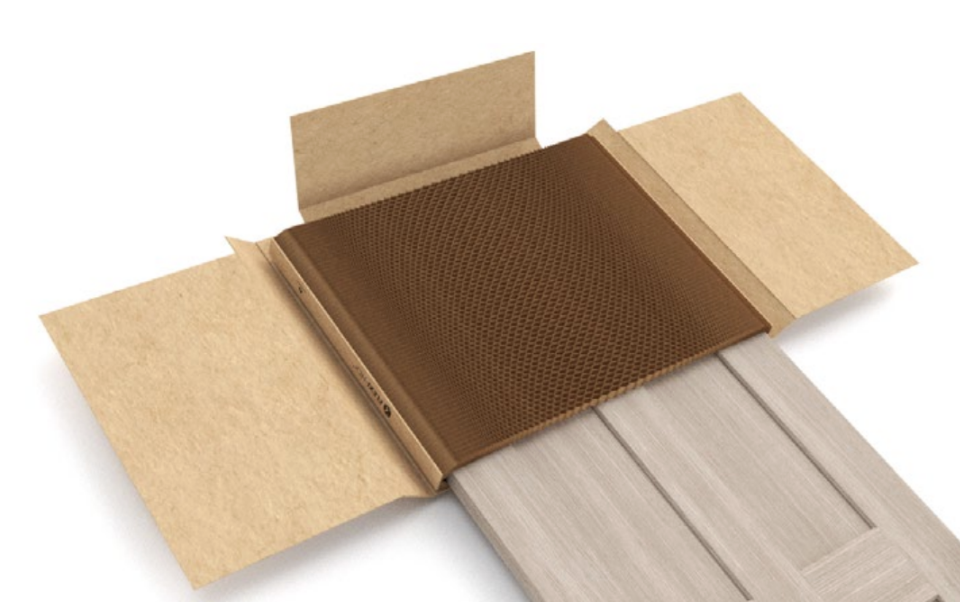 Brown honeycomb protective packaging partially wrapped around a wooden door.