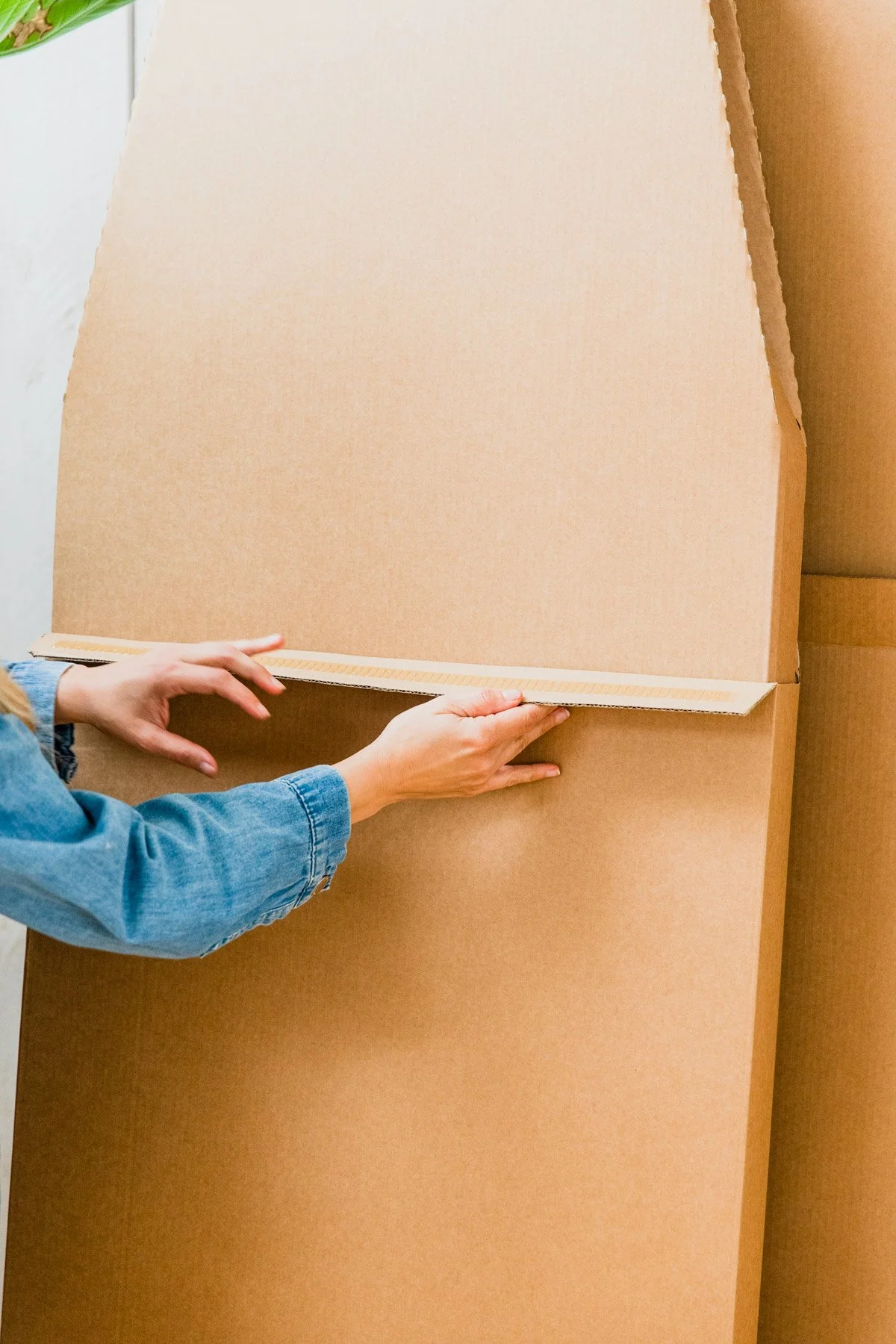 Person assembling a large cardboard box