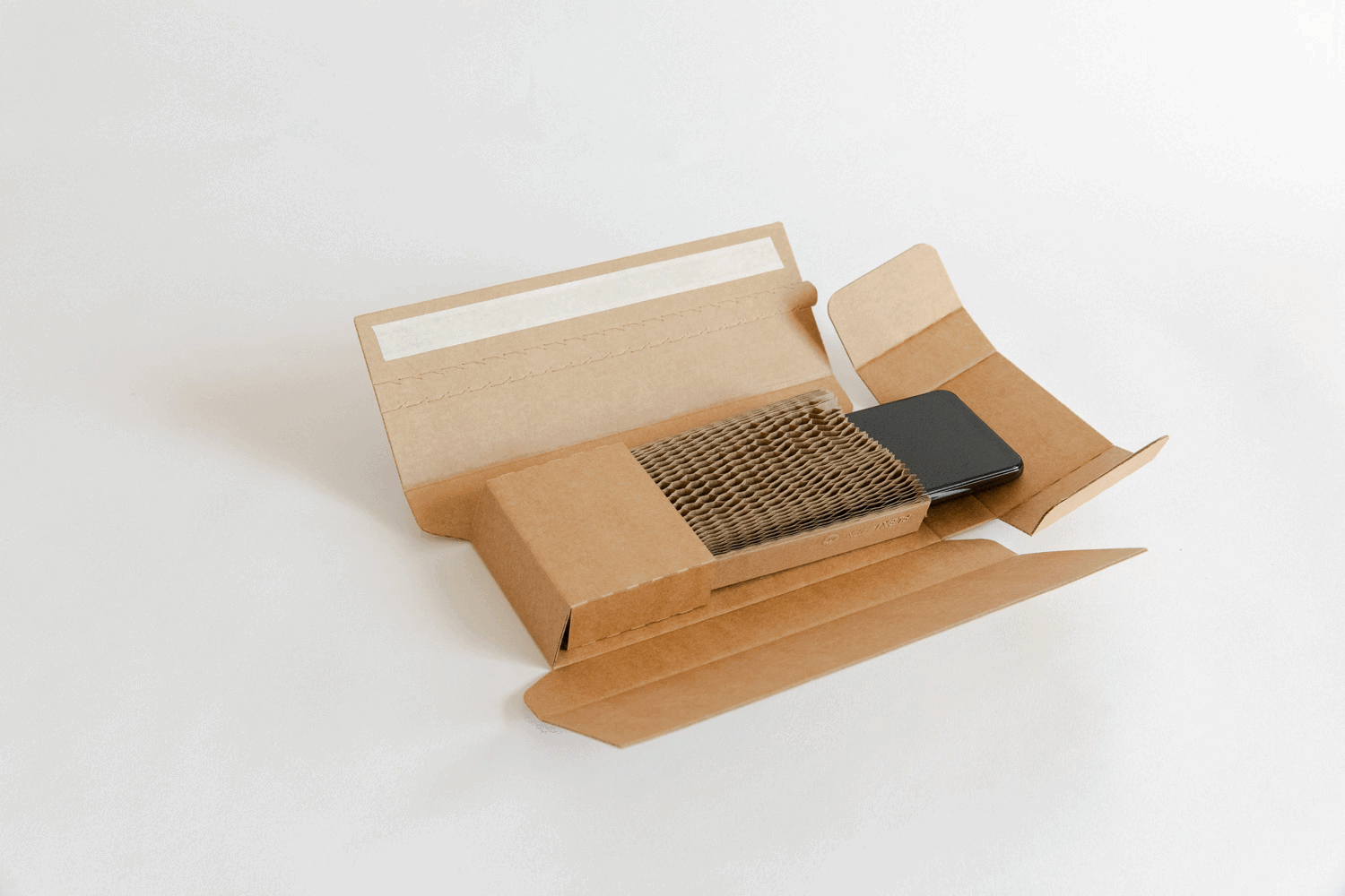 Open cardboard box containing an air filter and a black smartphone on a white background.