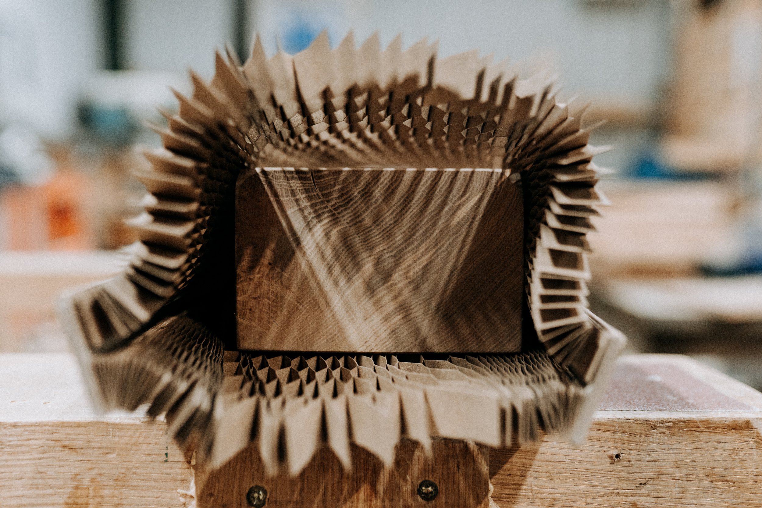 Wooden block surrounded by folded paper padding, focused view in workshop.