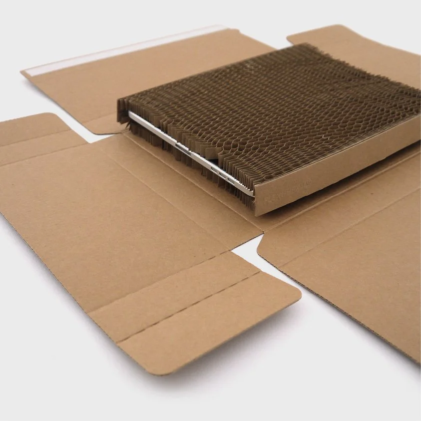 A cardboard box with a cooling pad inside, likely for an electronic device.