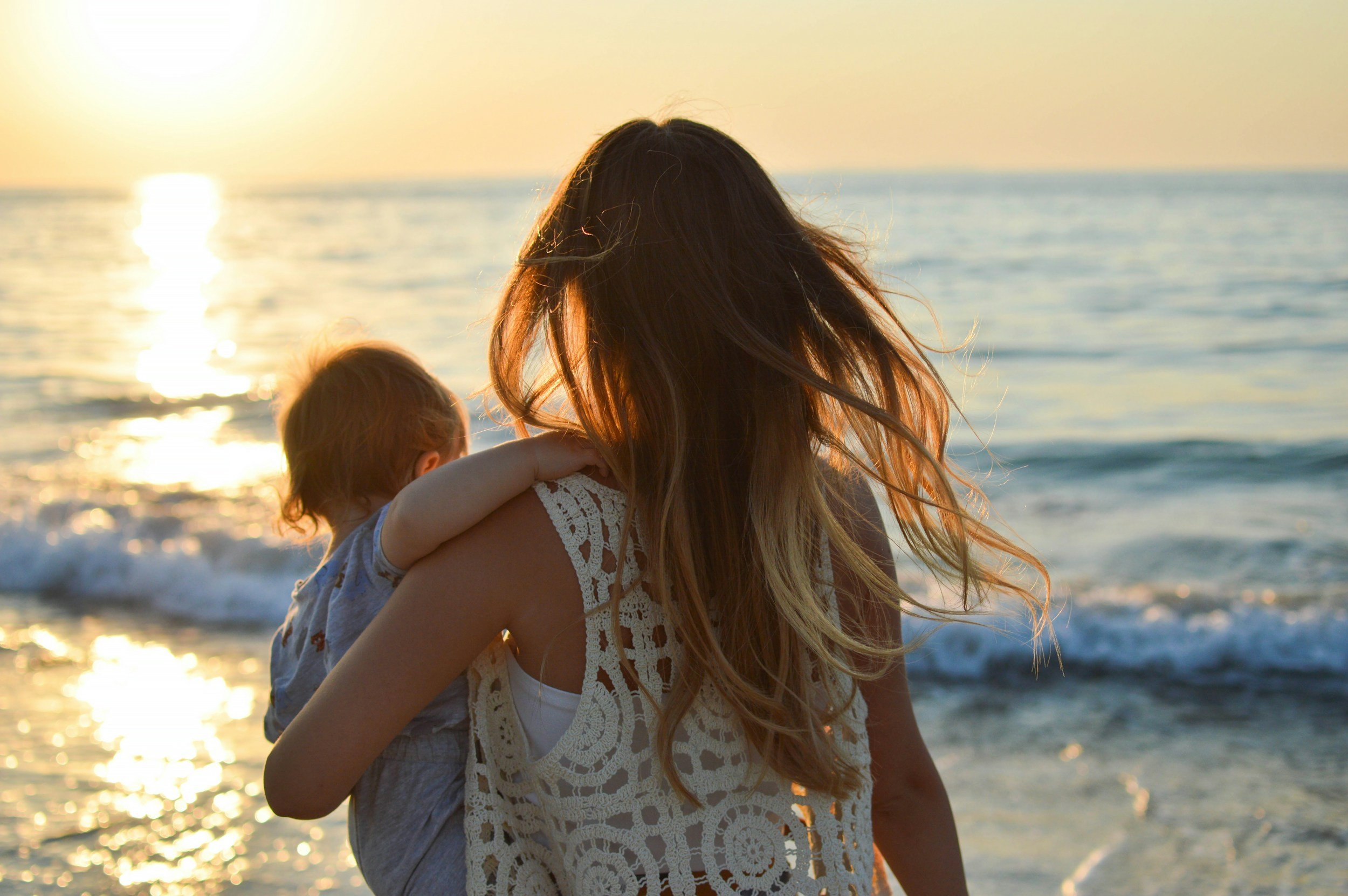 a blonde woman holding her young son