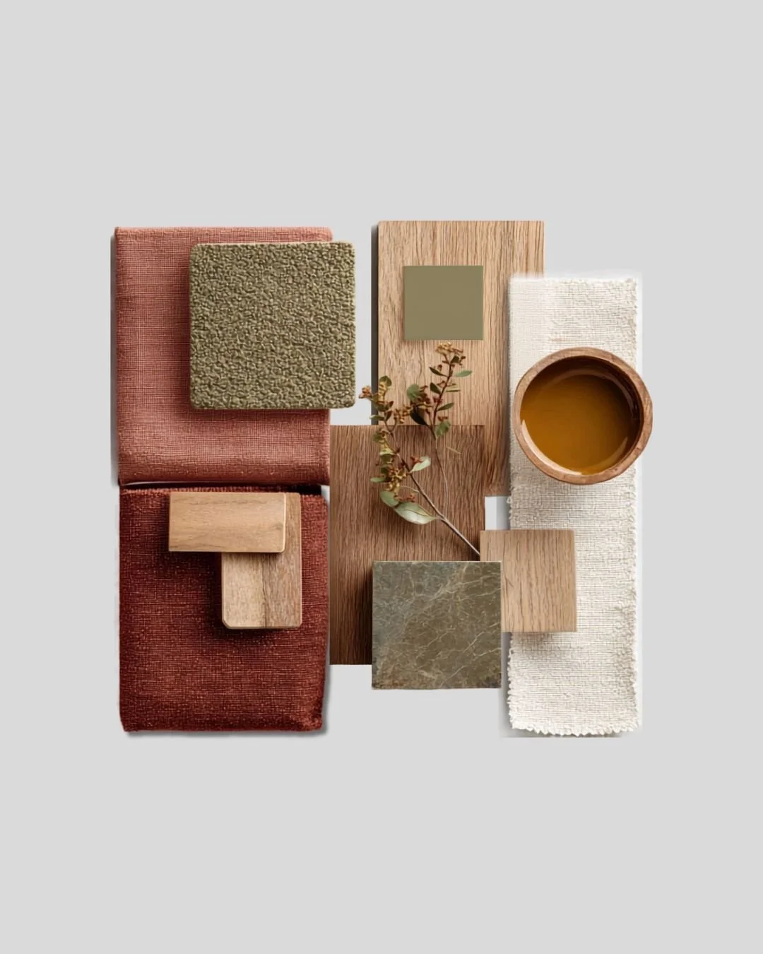 Arrangement of fabric swatches, wood sample, a small branch, a ceramic cup with tea or coffee, on a light background.