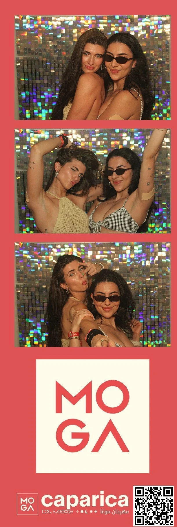 A photo booth strip with three pictures of two young women having fun, against a sparkling, colorful background. They are dressed in summer outfits, with one wearing sunglasses. The bottom section of the strip features logos and text promoting MOГА and Caparica, with a QR code.