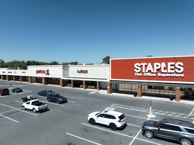 Shopping plaza with Staples, Petco, and Rainbow stores