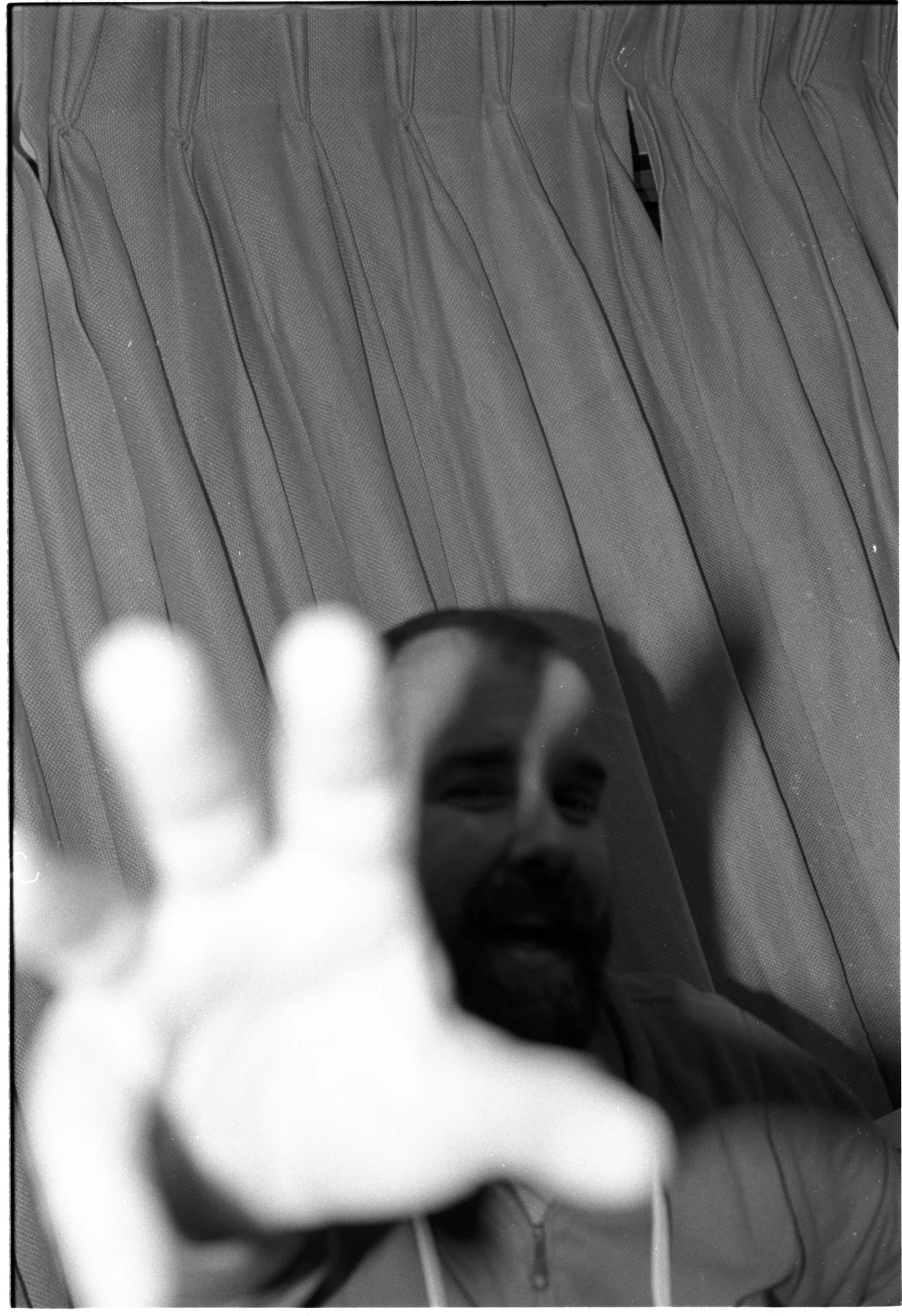 A hand reaches toward the camera in extreme motion blur.
