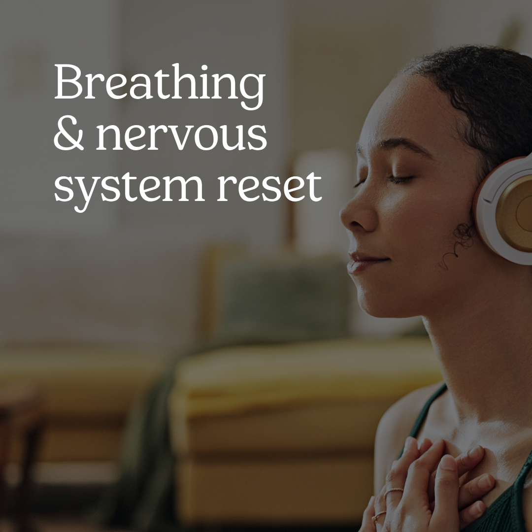 A woman sits with her eyes closed and hands placed gently over her chest. She is wearing white and gold headphones. The text reads “Breathing and nervous system reset.”