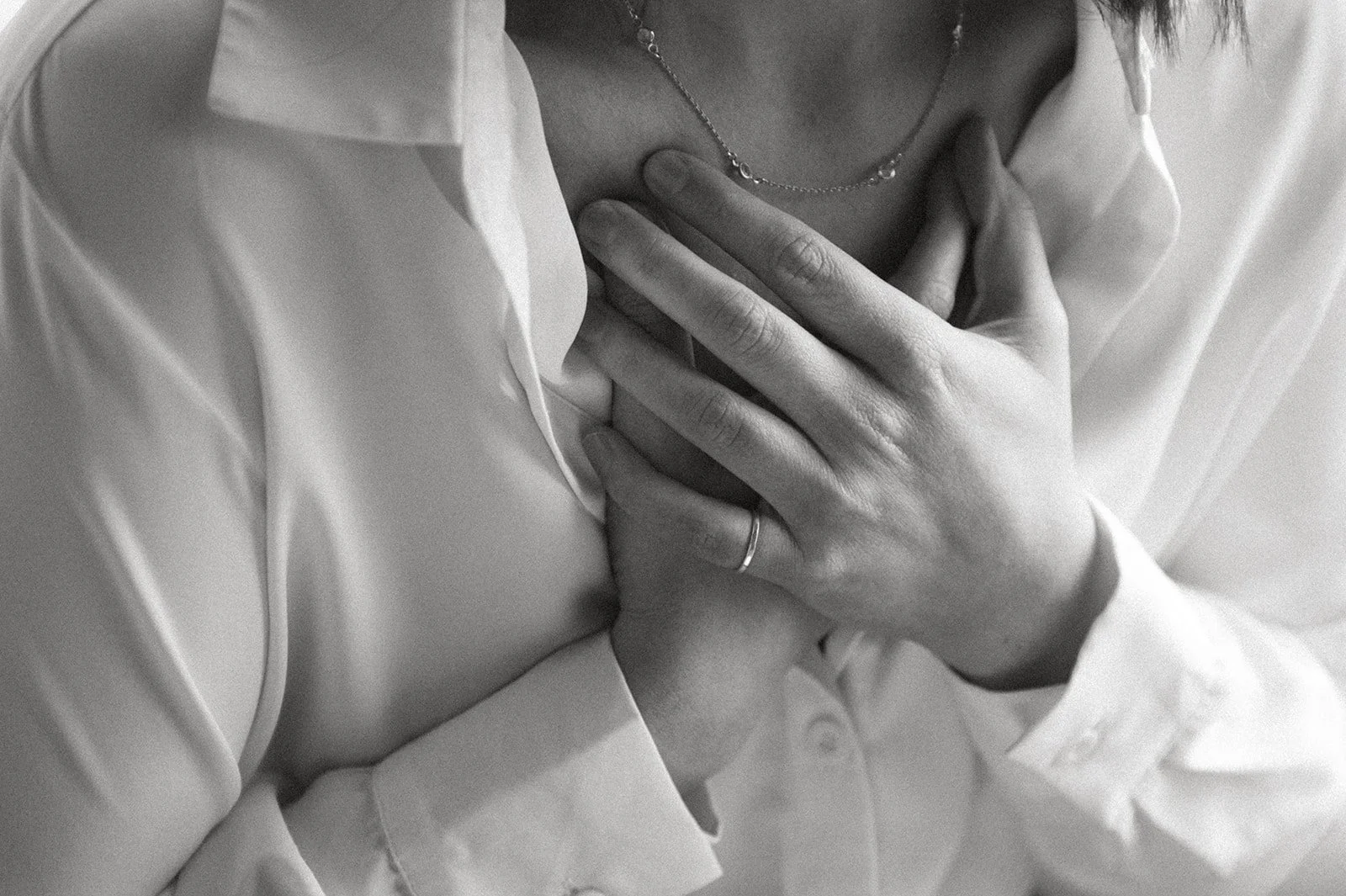 Hands holding heart chakra in emotional release session