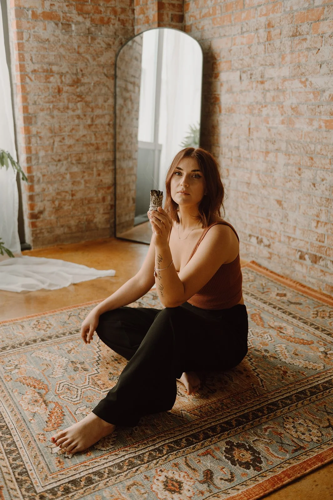 Reiki master Tora Savage waving sage