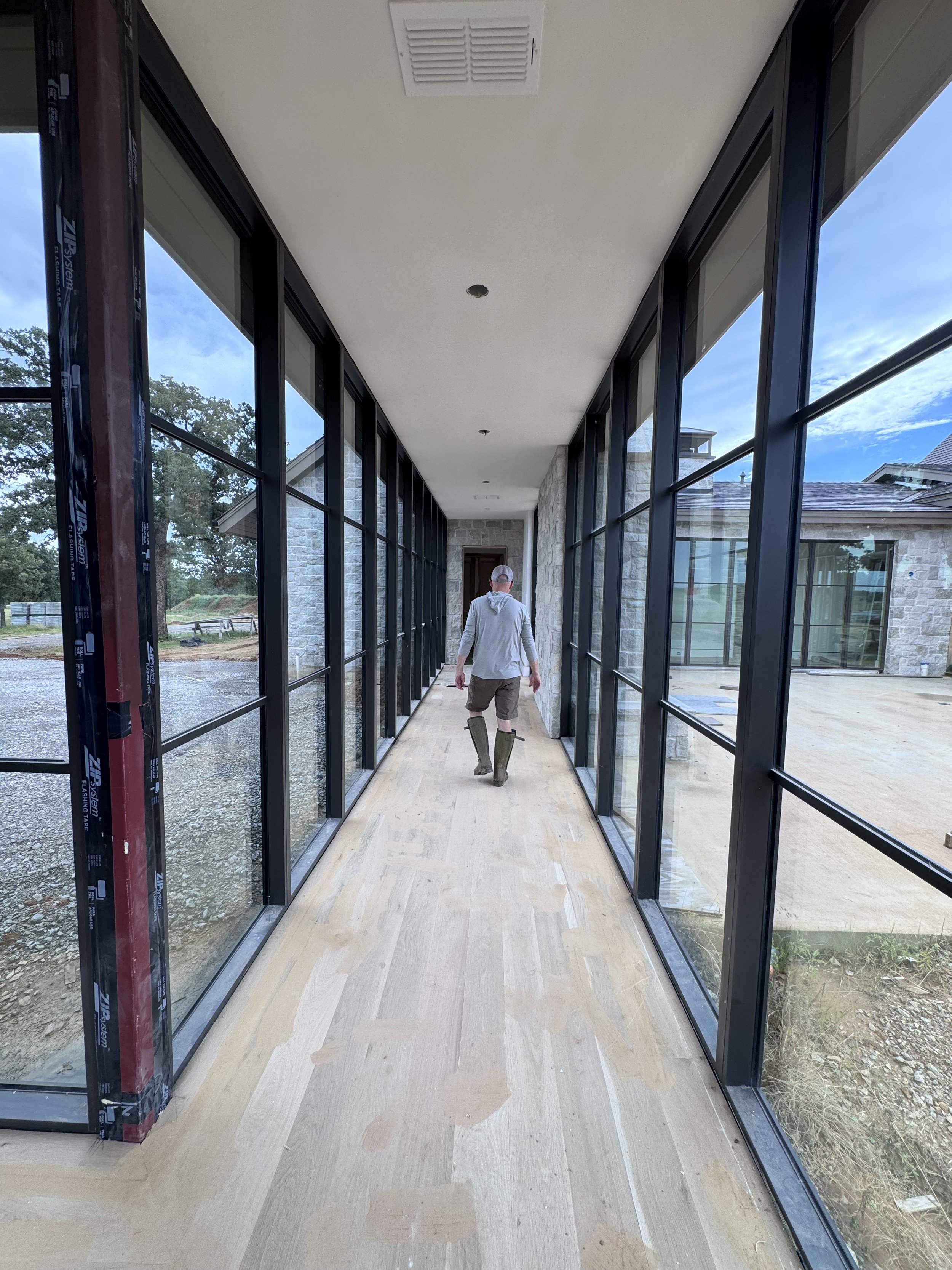 One of two glass corridors that connect the home’s living spaces.