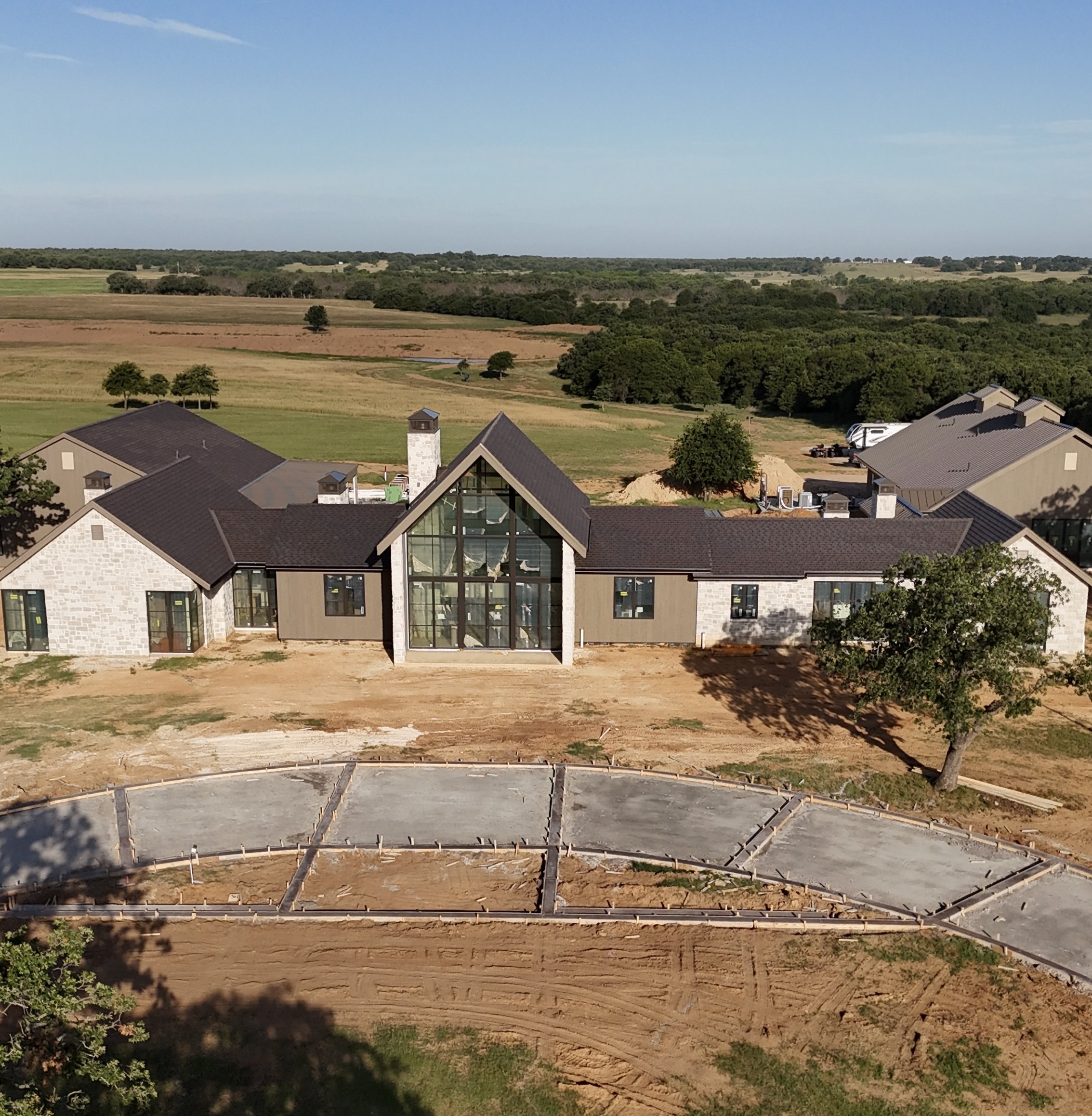 Front elevation of the main house and circle driveway progress at The Essex Ranch.