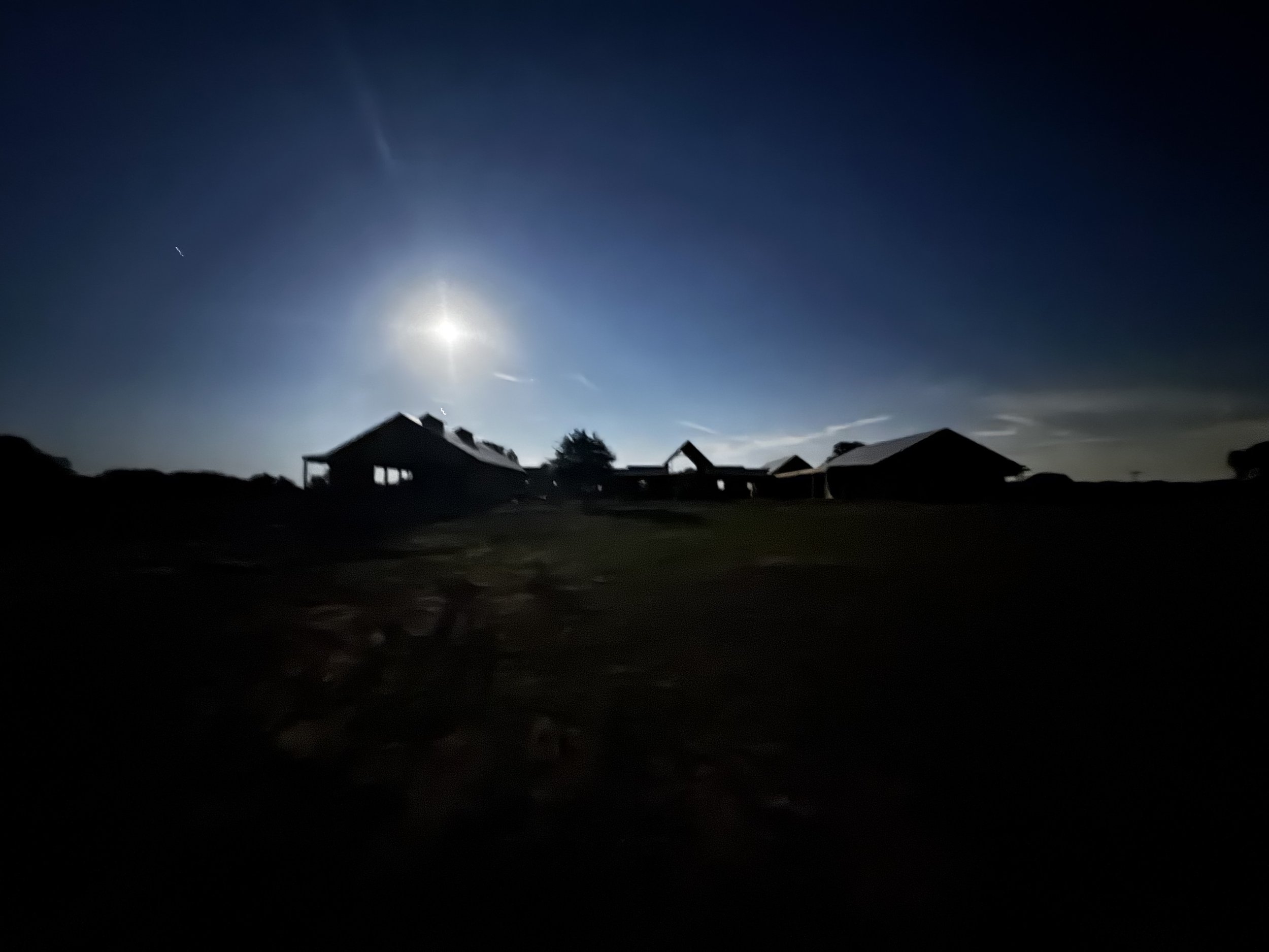 Under the glow of a full moon, Essex Ranch transforms into a tranquil, dreamlike setting. The silhouettes of the ranch buildings stand proudly against the night sky, illuminated only by the moon’s gentle light. This peaceful, untouched photo feels li