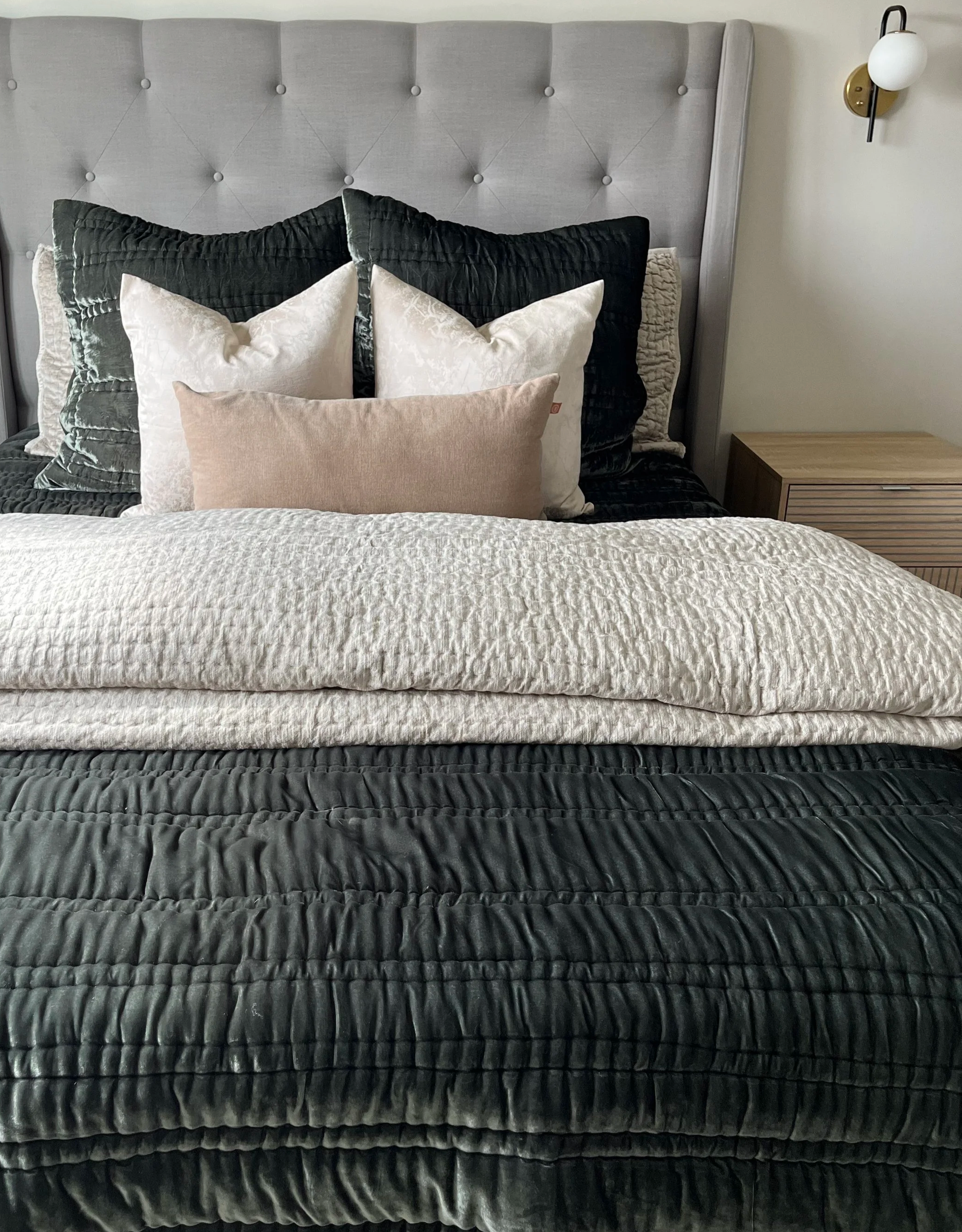 Luxury bedroom design with upholstered headboard and layered neutral bedding in Lakeway TX