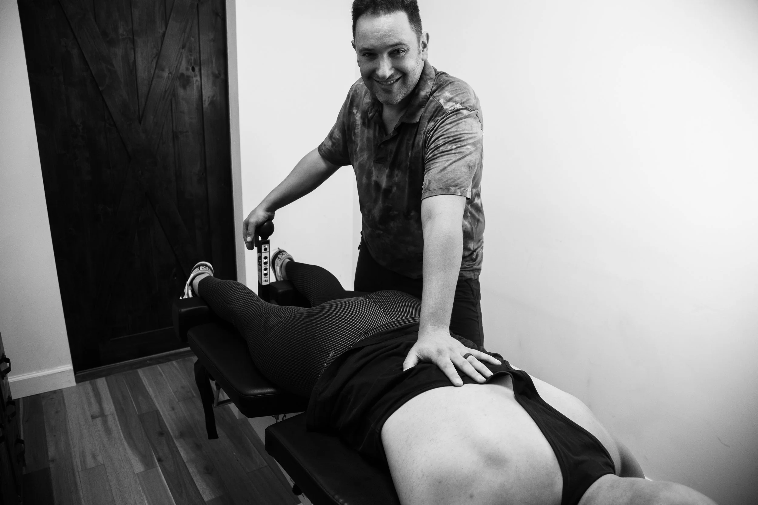 Dr. Jason Fidler performing COX flexion-distraction spinal decompression treatment on a patient at Functional Rehab in Brooklyn