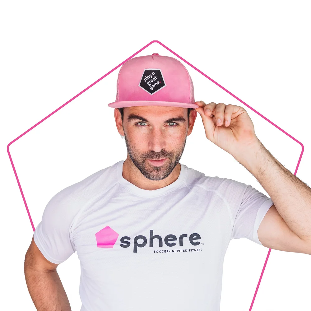 Michael Chabala wearing a pink cap and white Sphere shirt